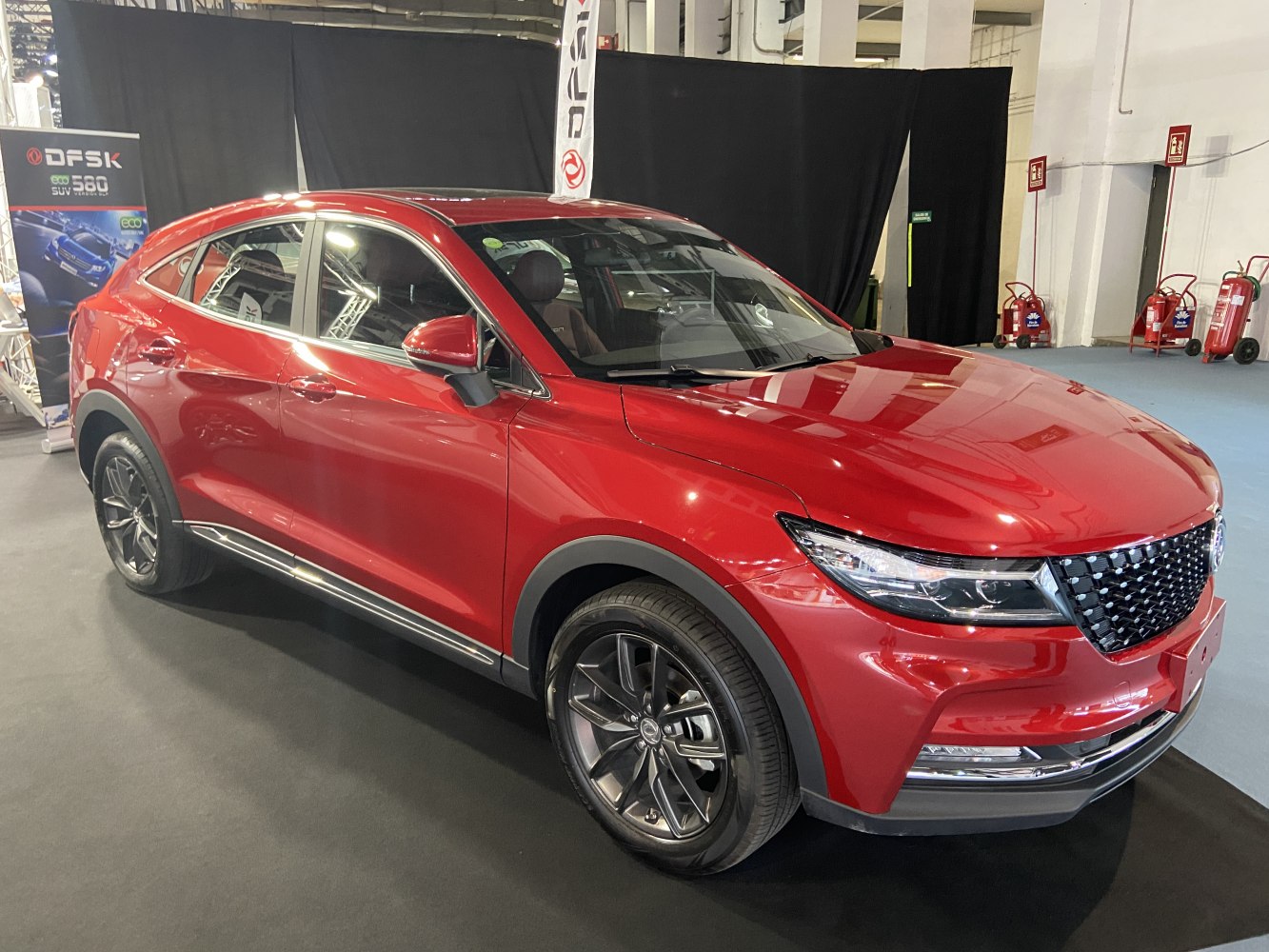 Red compact SUV with sleek grille and alloy wheels