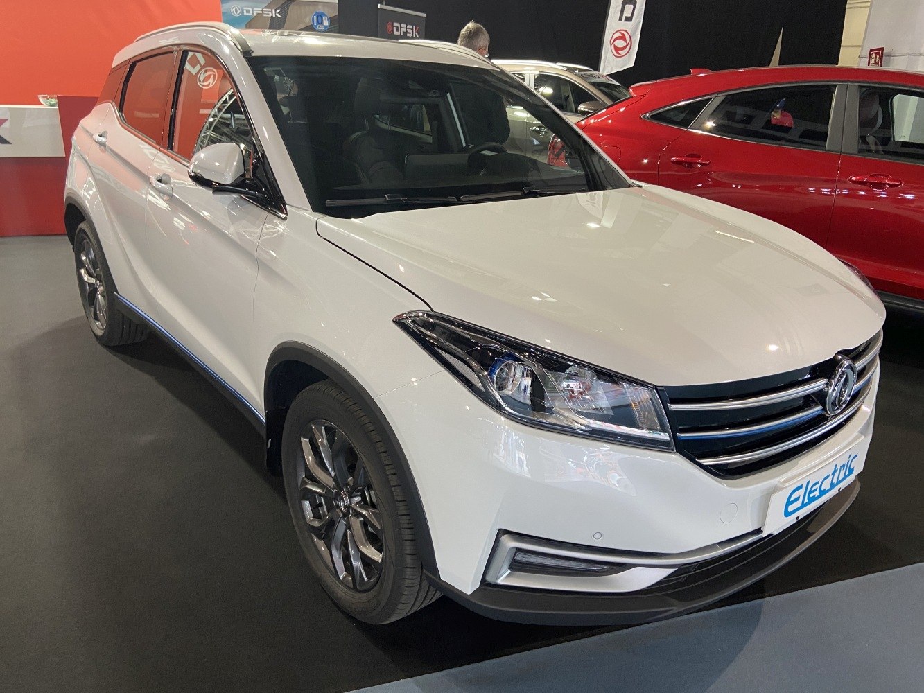 Front and side view of white electric SUV with modern headlights and grille