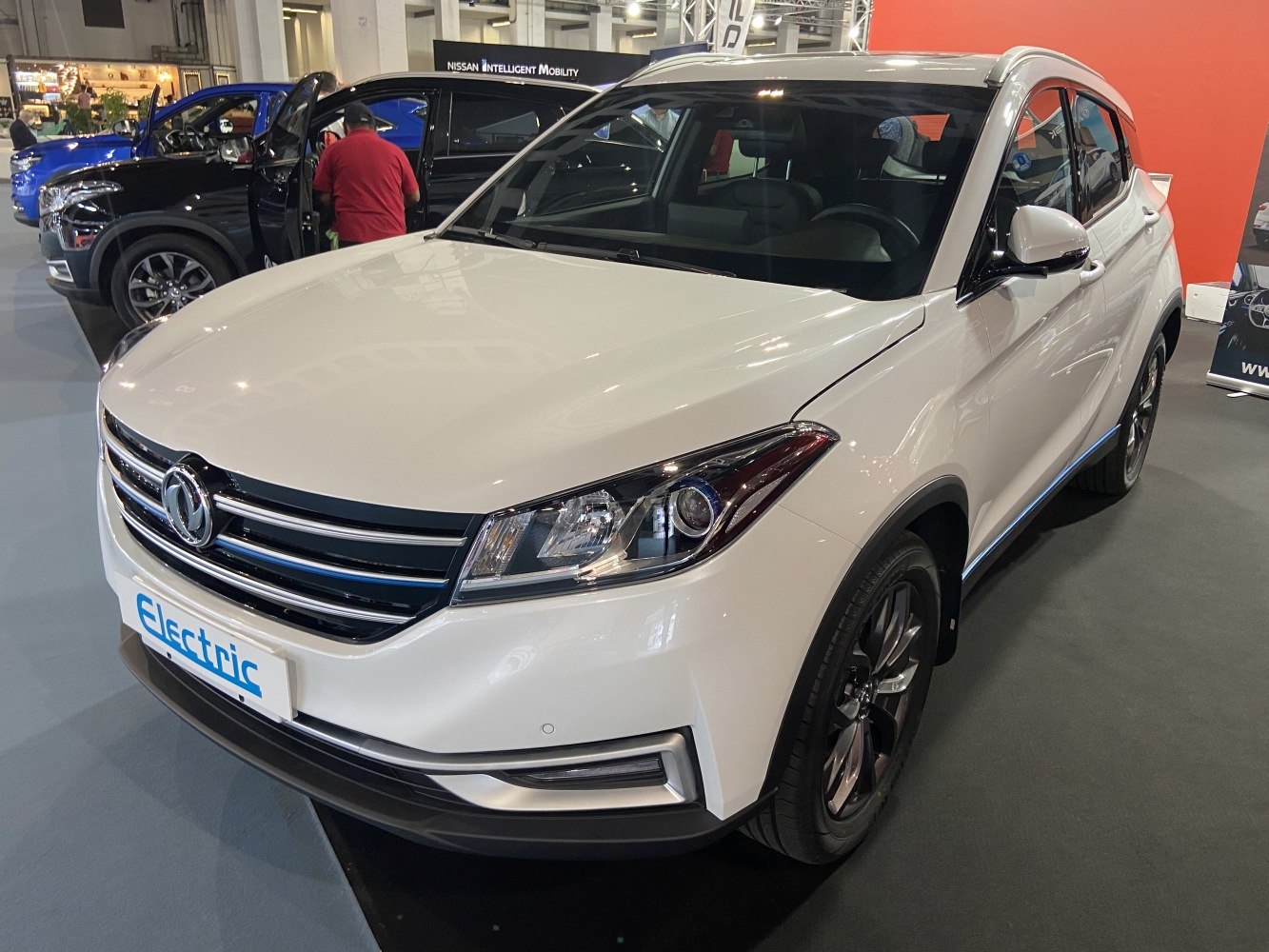 Front and side profile of white electric SUV with sleek headlights.