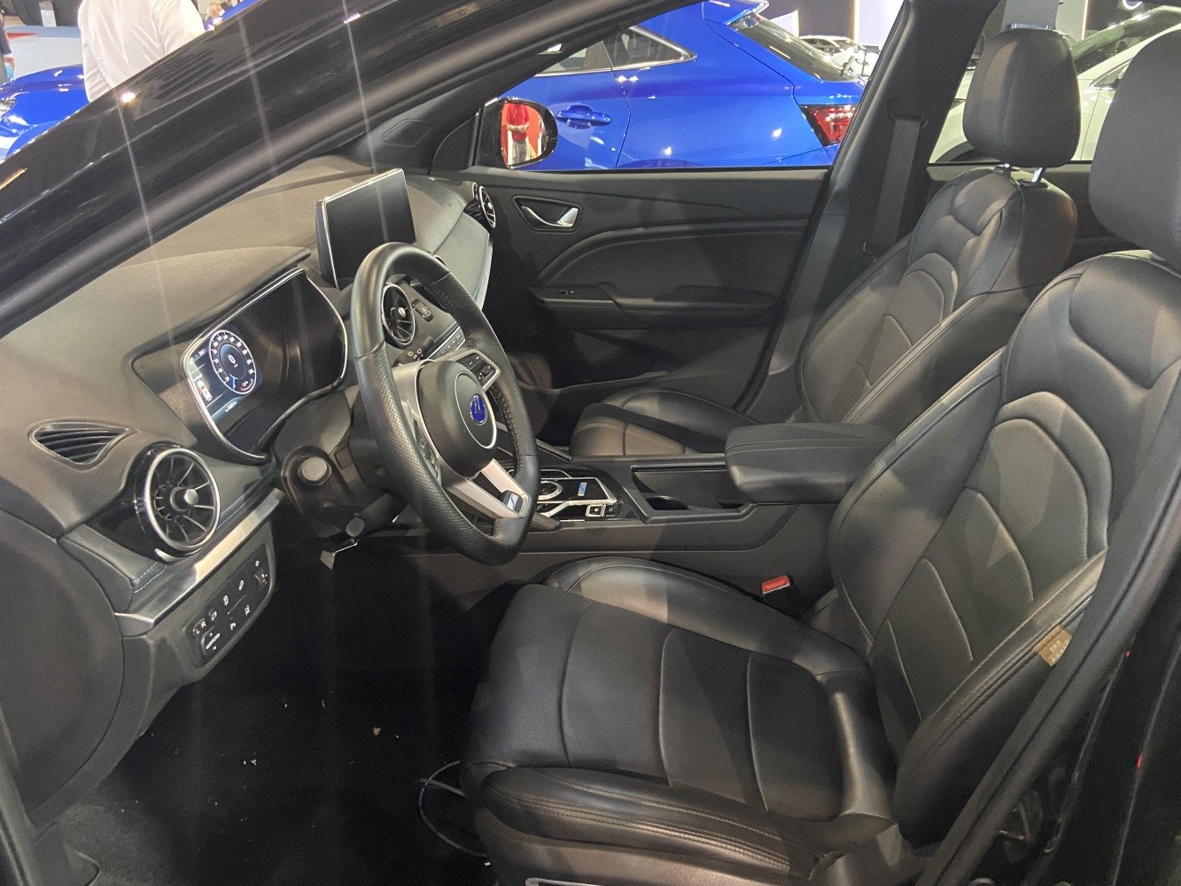 Modern black leather seats and digital dashboard with touchscreen display