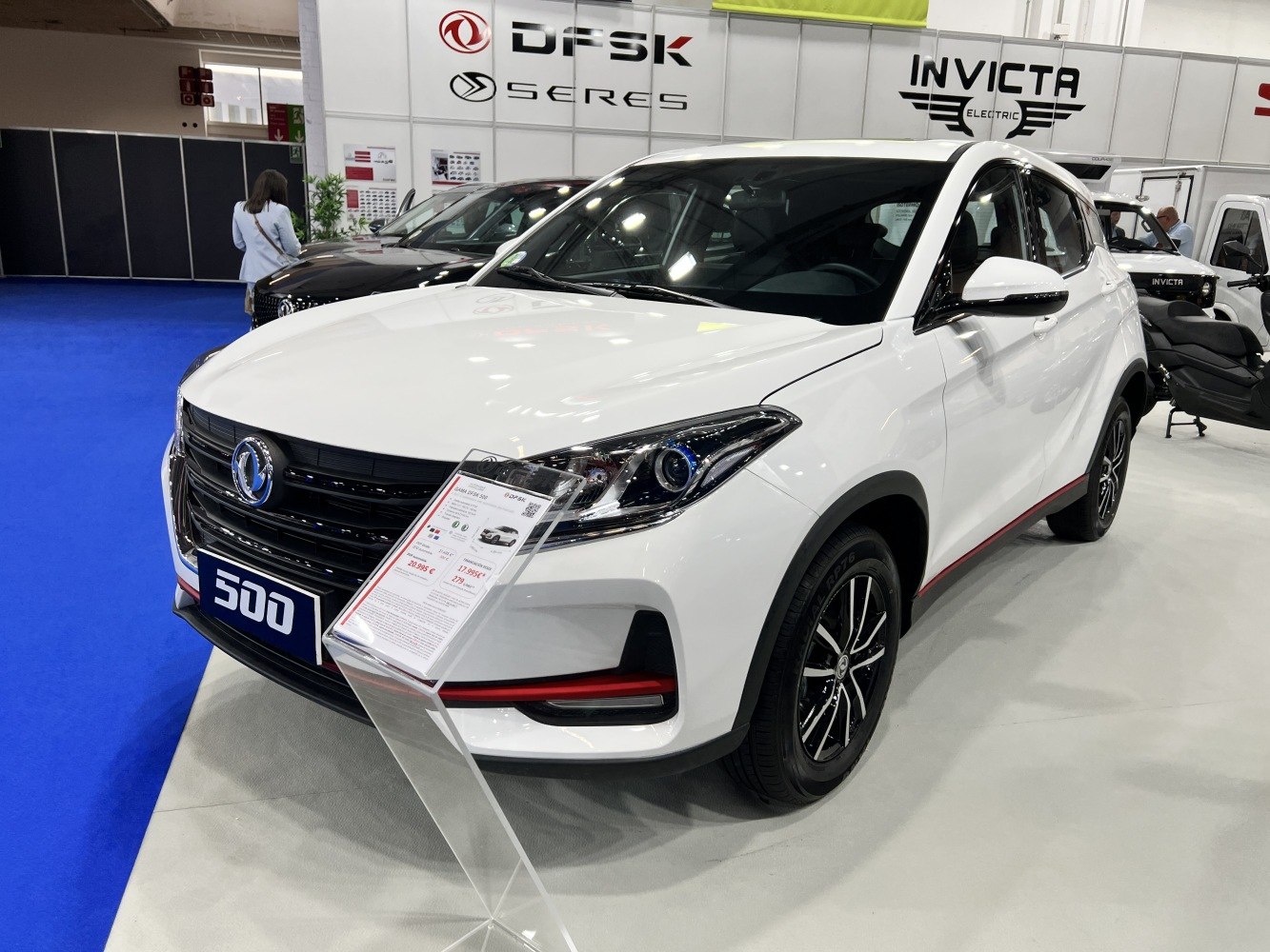 White SUV with sleek headlights, black grille, and sporty alloy wheels with red accent strip