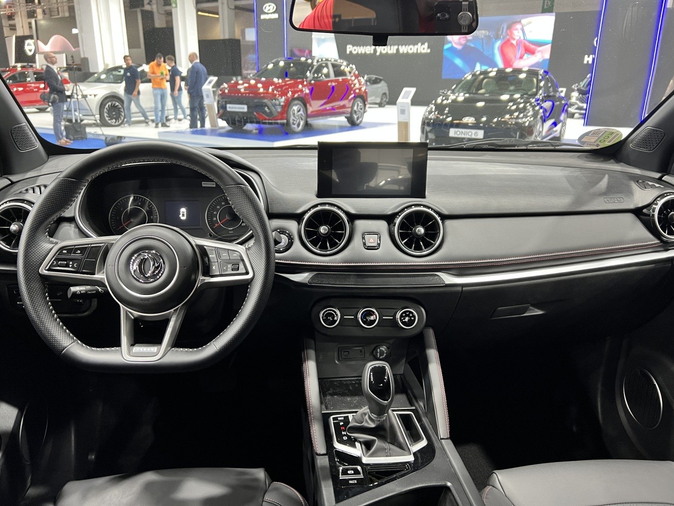 Car dashboard with circular air vents and infotainment display