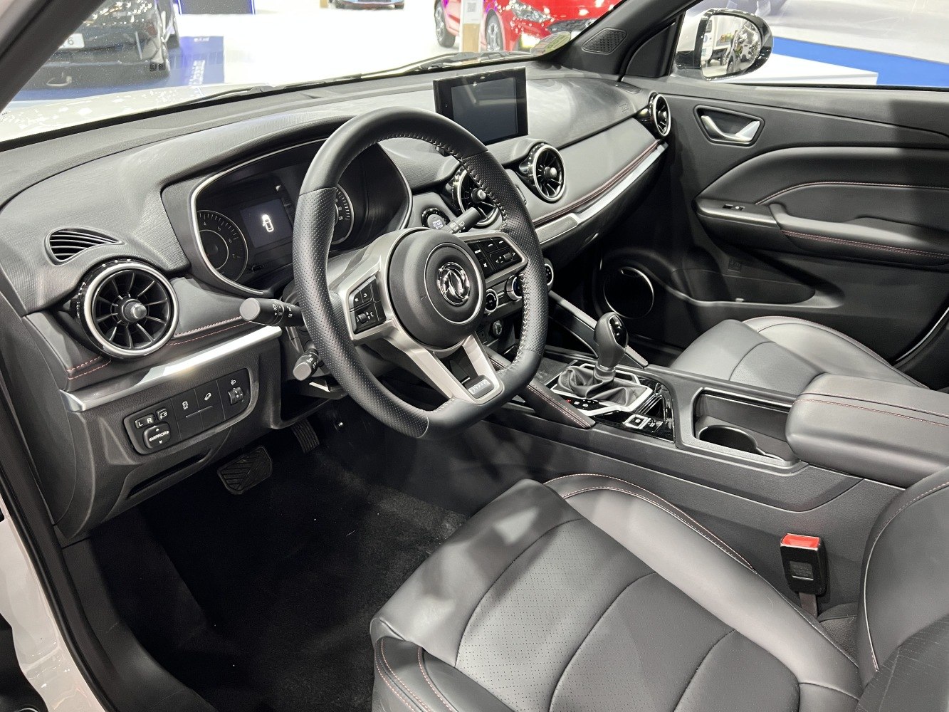 Modern car interior with digital display, steering wheel, and leather seats