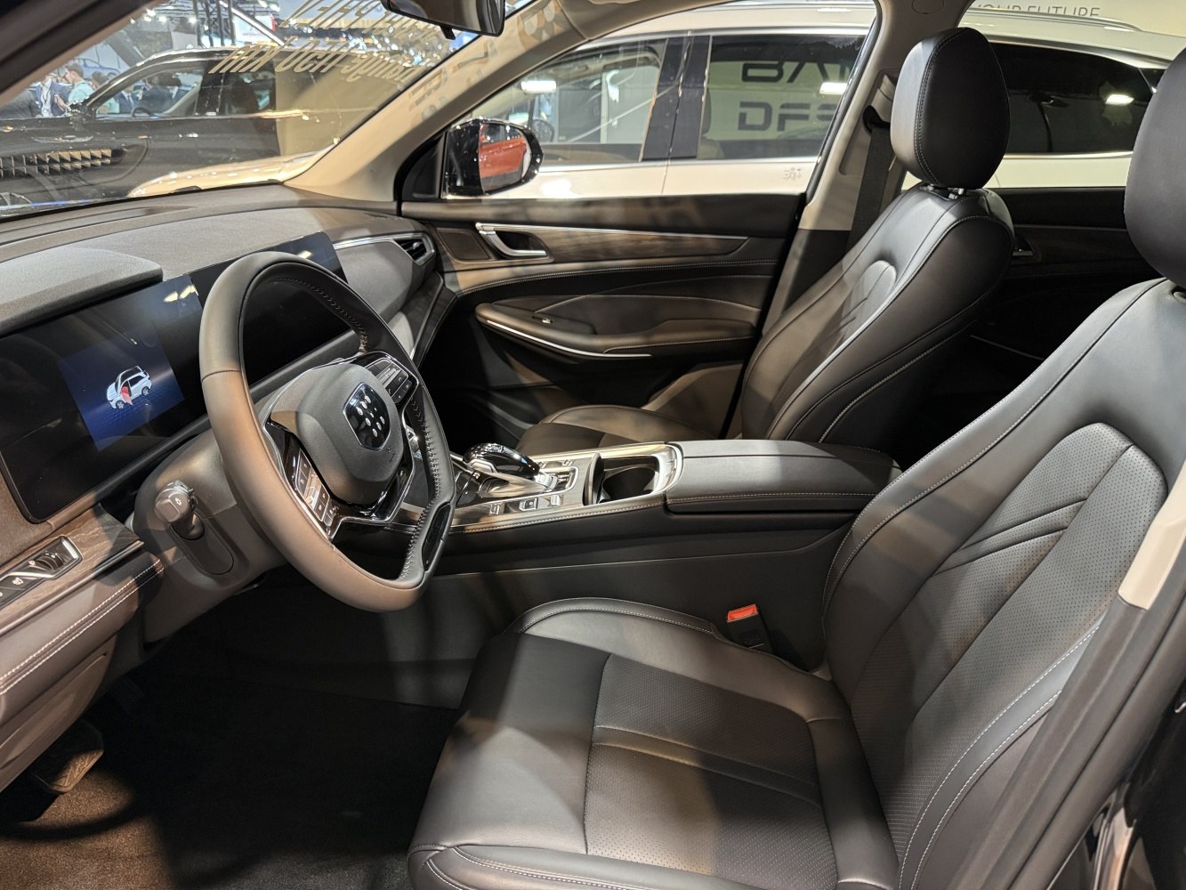 Luxury black leather seats with digital dashboard and center console controls.
