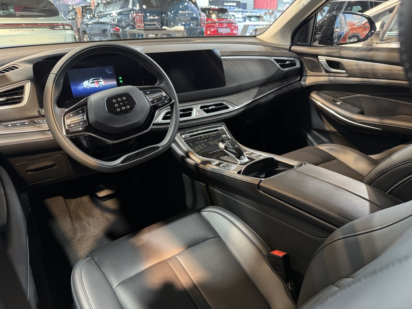 Modern digital dashboard and sleek center console with steering wheel controls