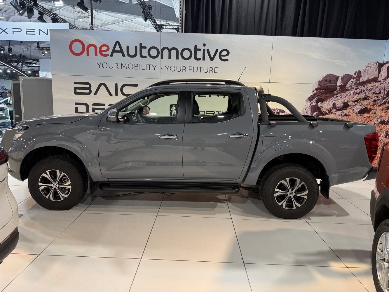 Double cab pickup truck with roll bar and alloy wheels