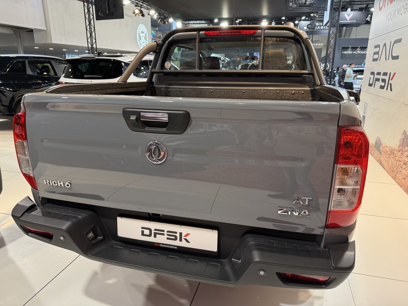 Open rear tailgate and cargo bed with protective liner and roll bar