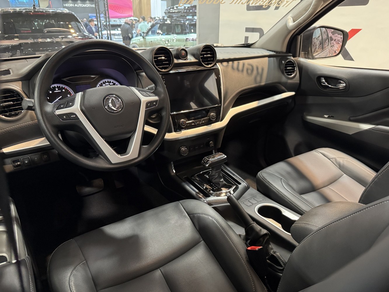 Modern car interior with dashboard, multifunction steering wheel, and gear selector