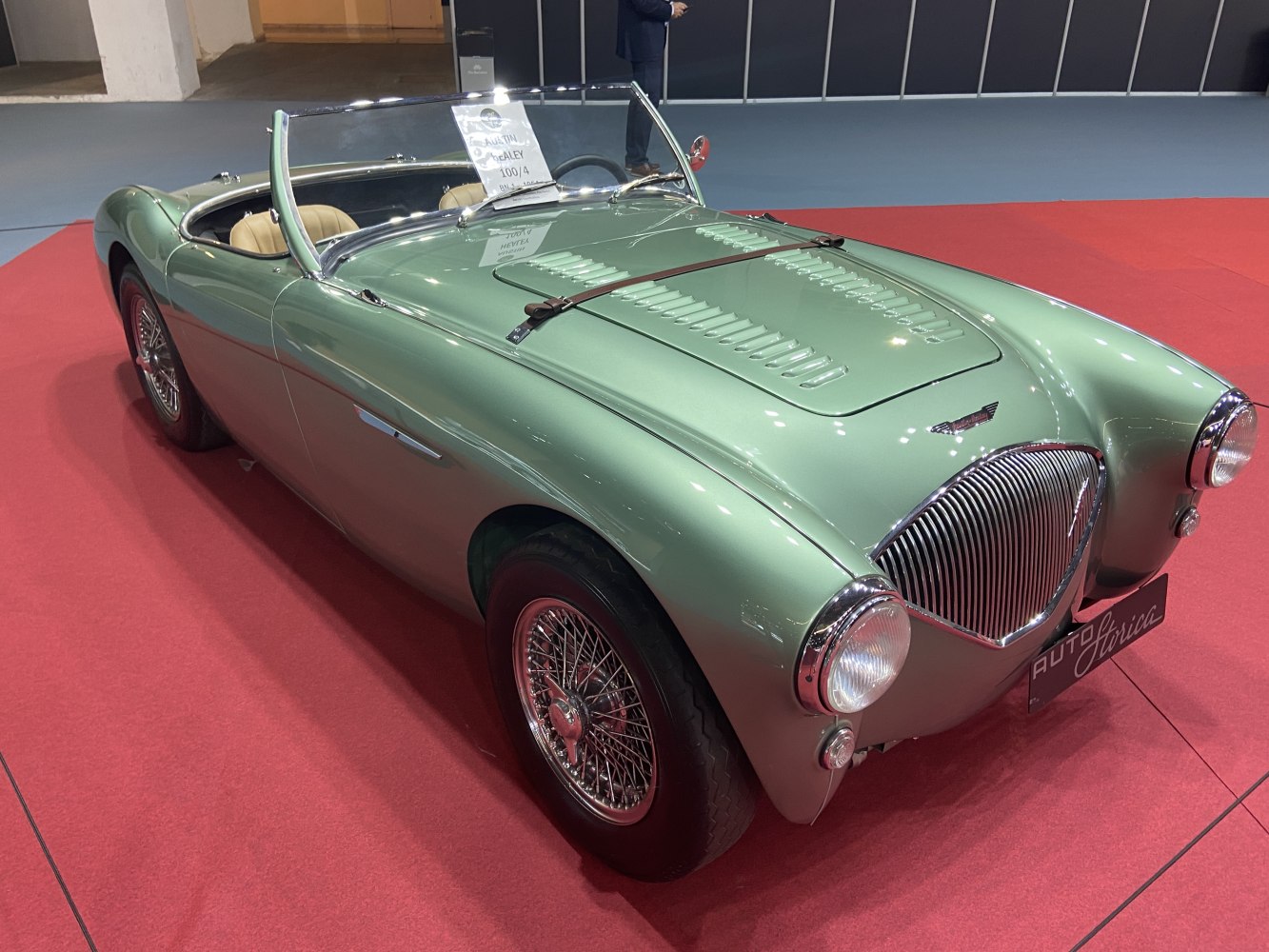 Classic vintage roadster with ventilated hood, distinctive front grille, wire wheels, and open-top design
