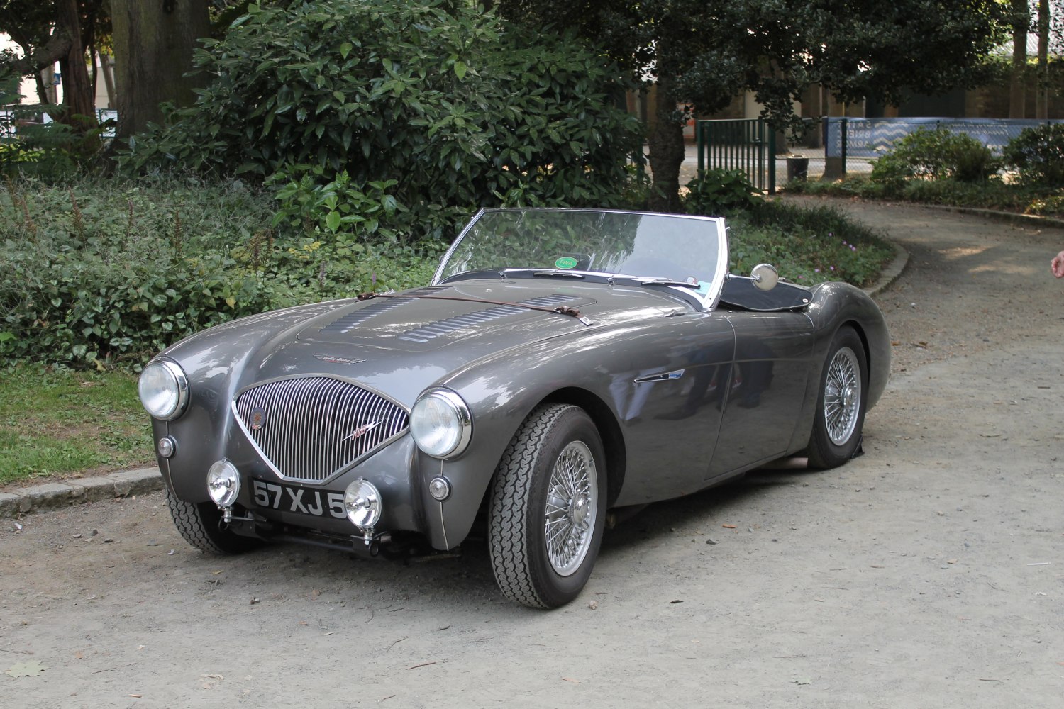 Vintage open-top roadster with curved grille and wire spoke wheels