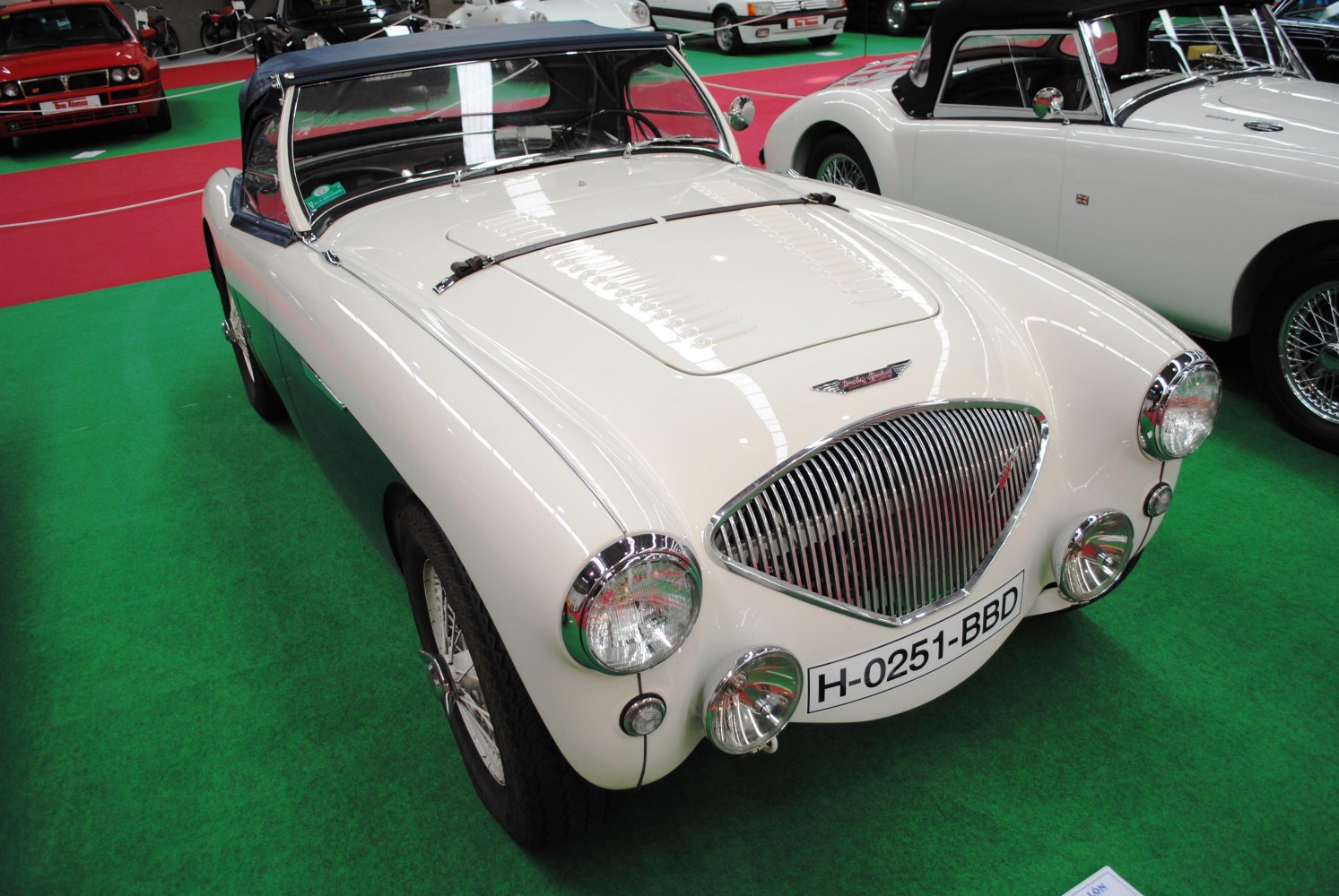 Vintage convertible with vertical slat grille and round headlights