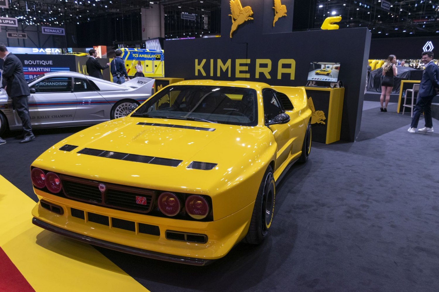 Bright yellow performance car front view with quad circular lights and racing tires