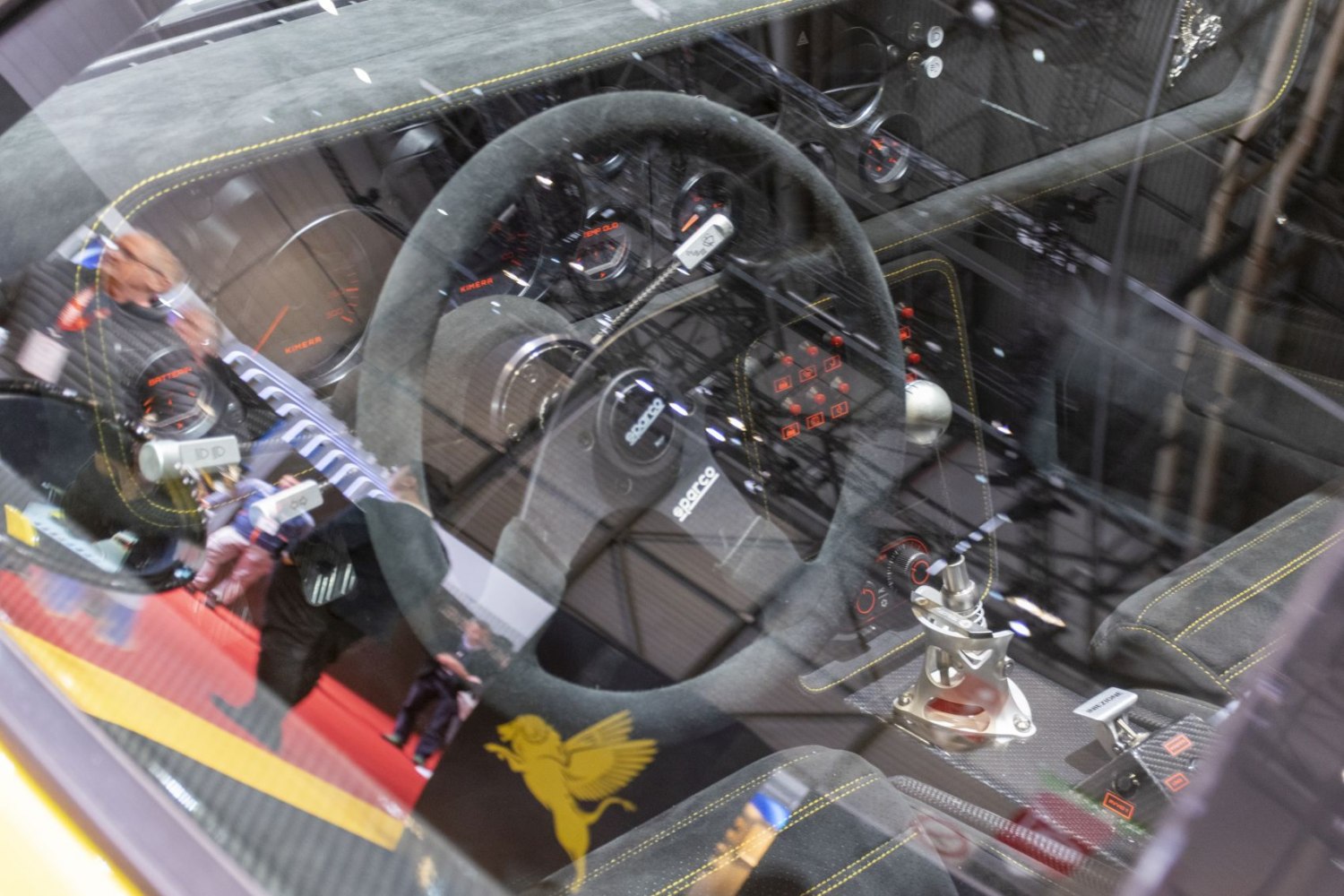 Racing steering wheel and gear shifter with detailed gauges and yellow stitching