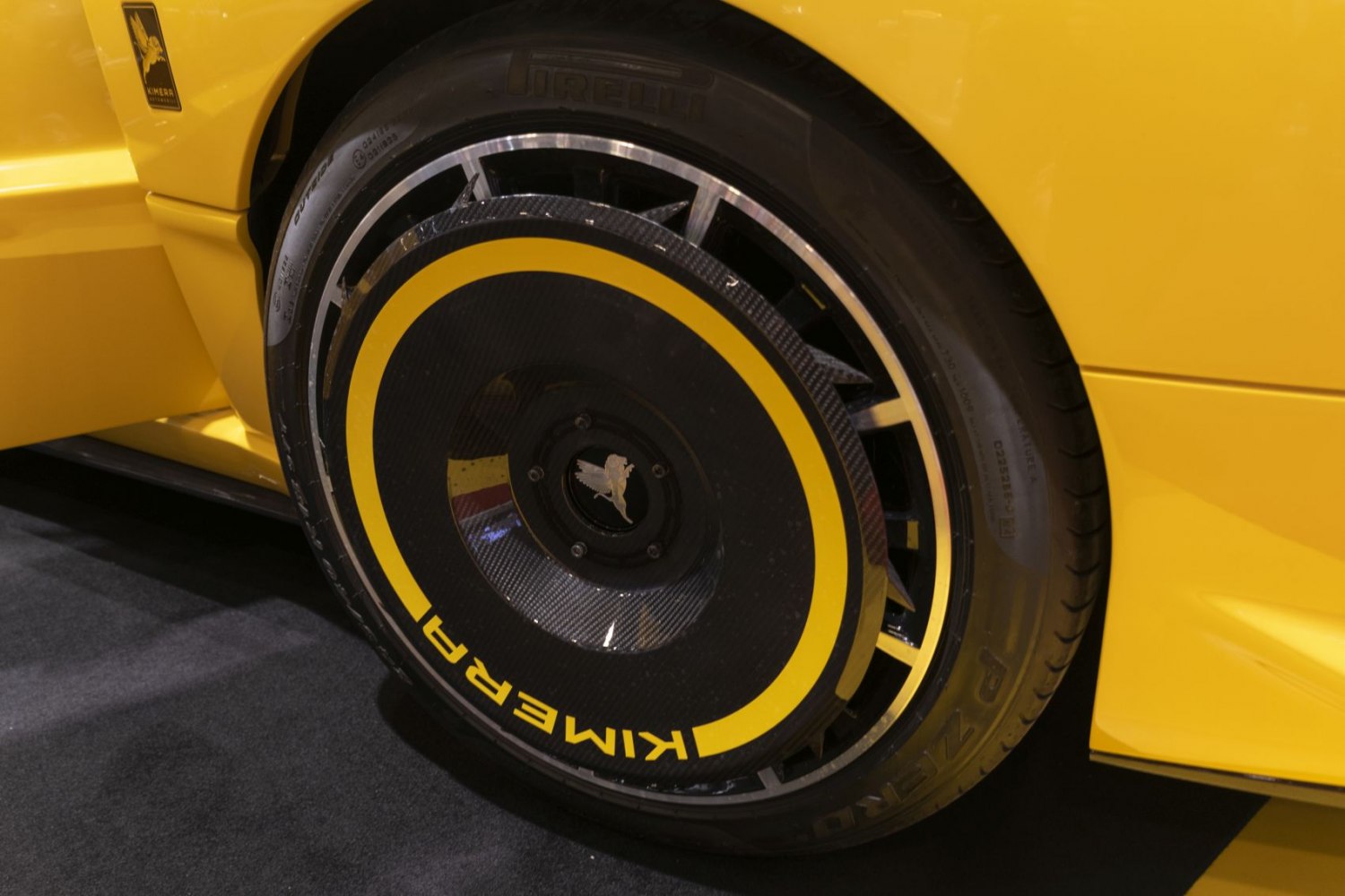 Aerodynamic carbon fiber rear wheel disc with yellow accents on tire