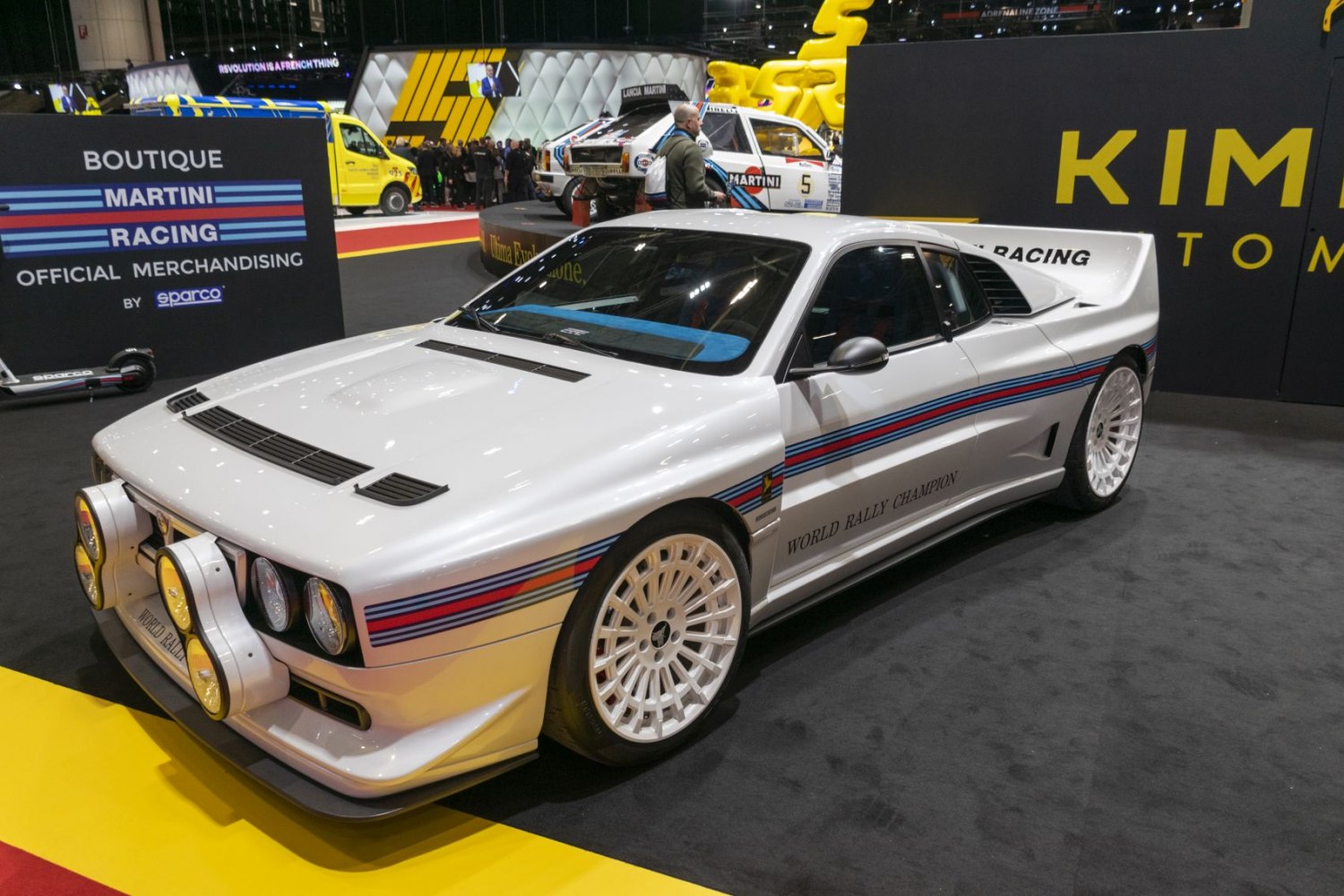 Rally car with Martini Racing stripes and multiple front spotlights