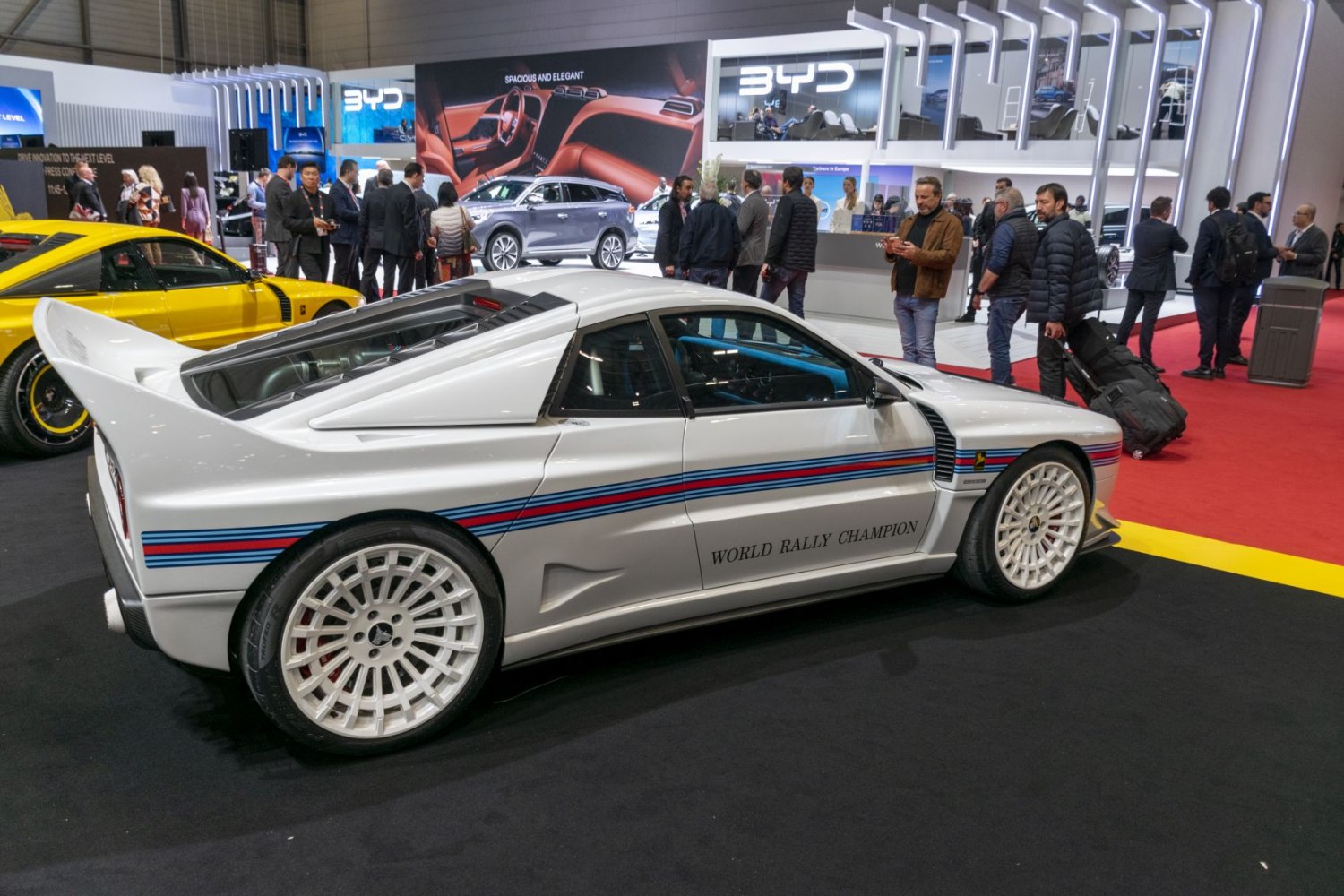 White rally car with Martini heritage stripes and white racing wheels