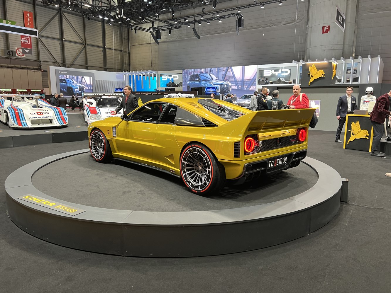 Bold yellow sports car with prominent rear wing and detailed alloy wheels