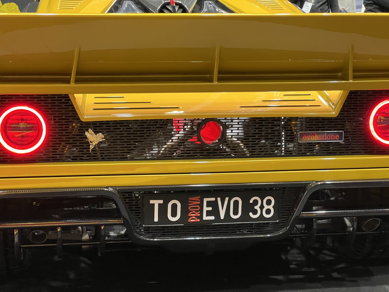 Rear view with circular LED taillights and rear diffuser in yellow body