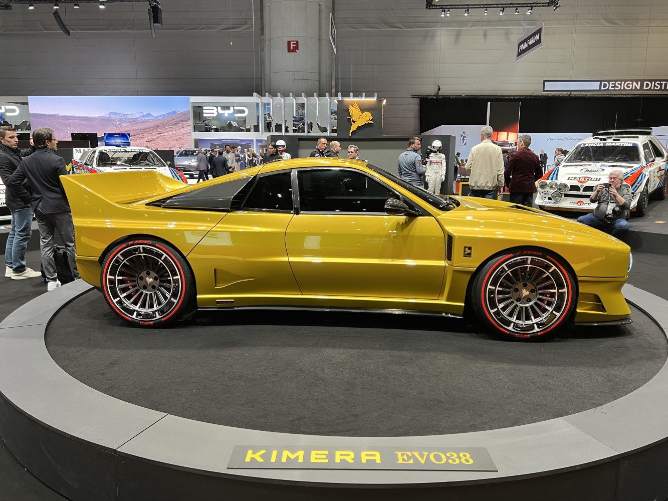Yellow sports car side view with large rear wing and sporty wheels