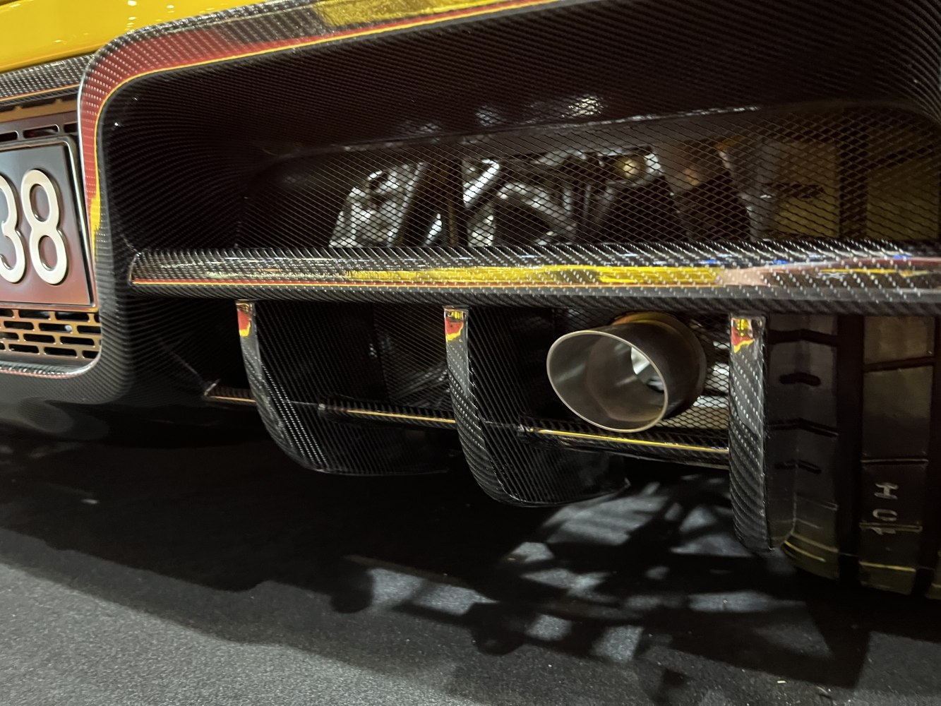 Carbon fiber rear diffuser with single exhaust pipe