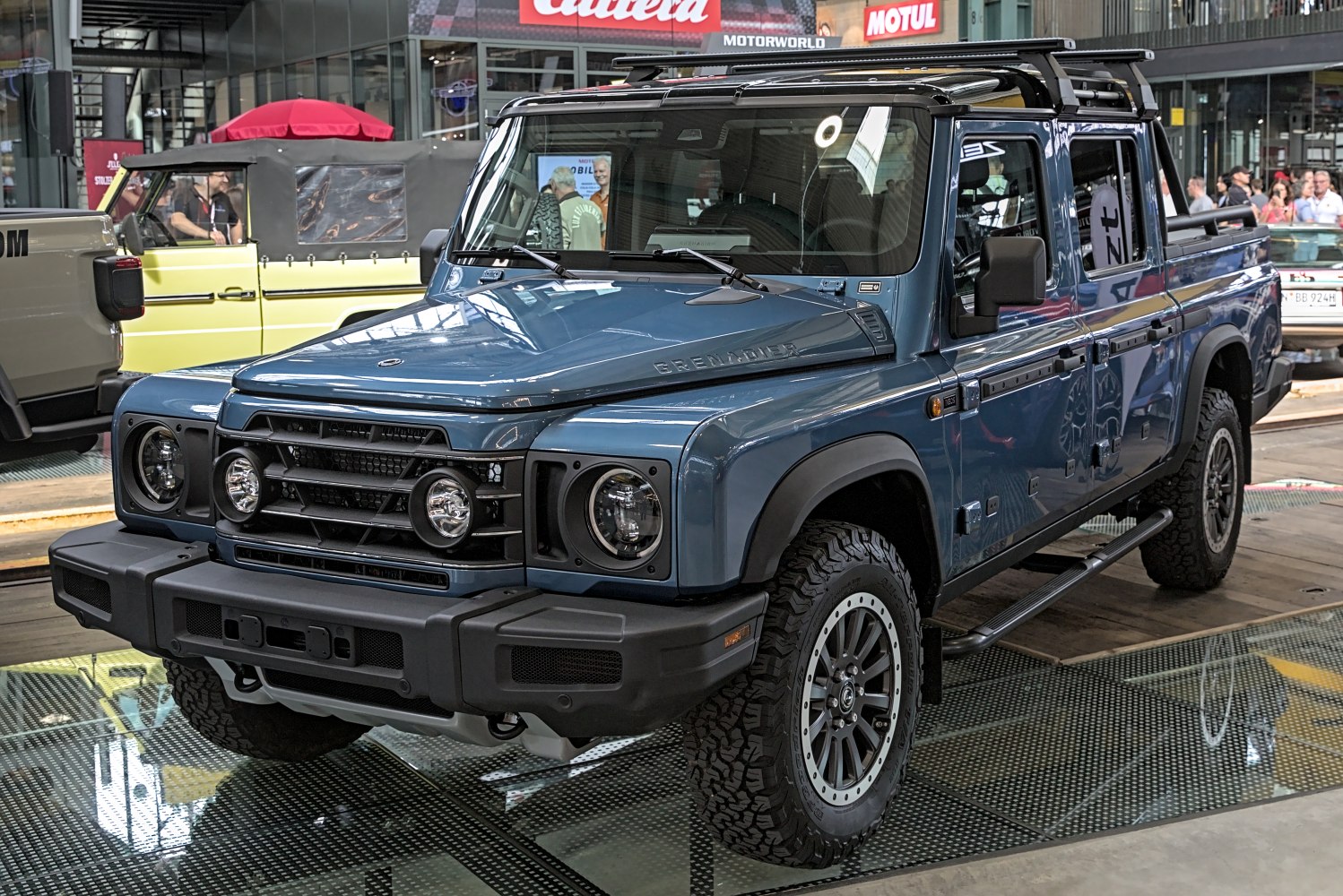 Robust off-road pickup with front grille and all-terrain tires
