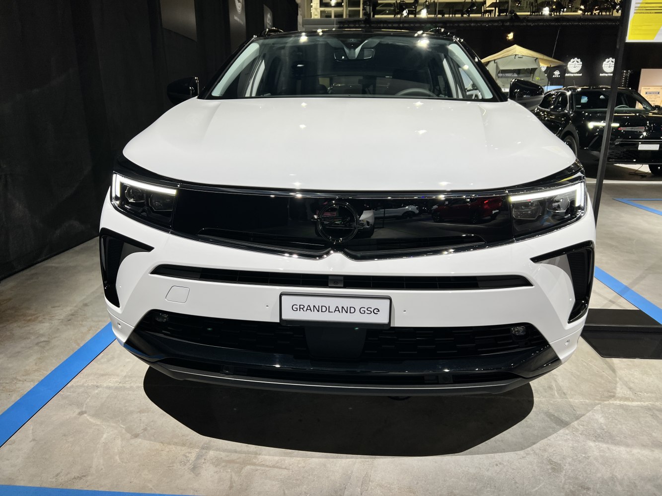 Front design with LED headlights and black grille panel