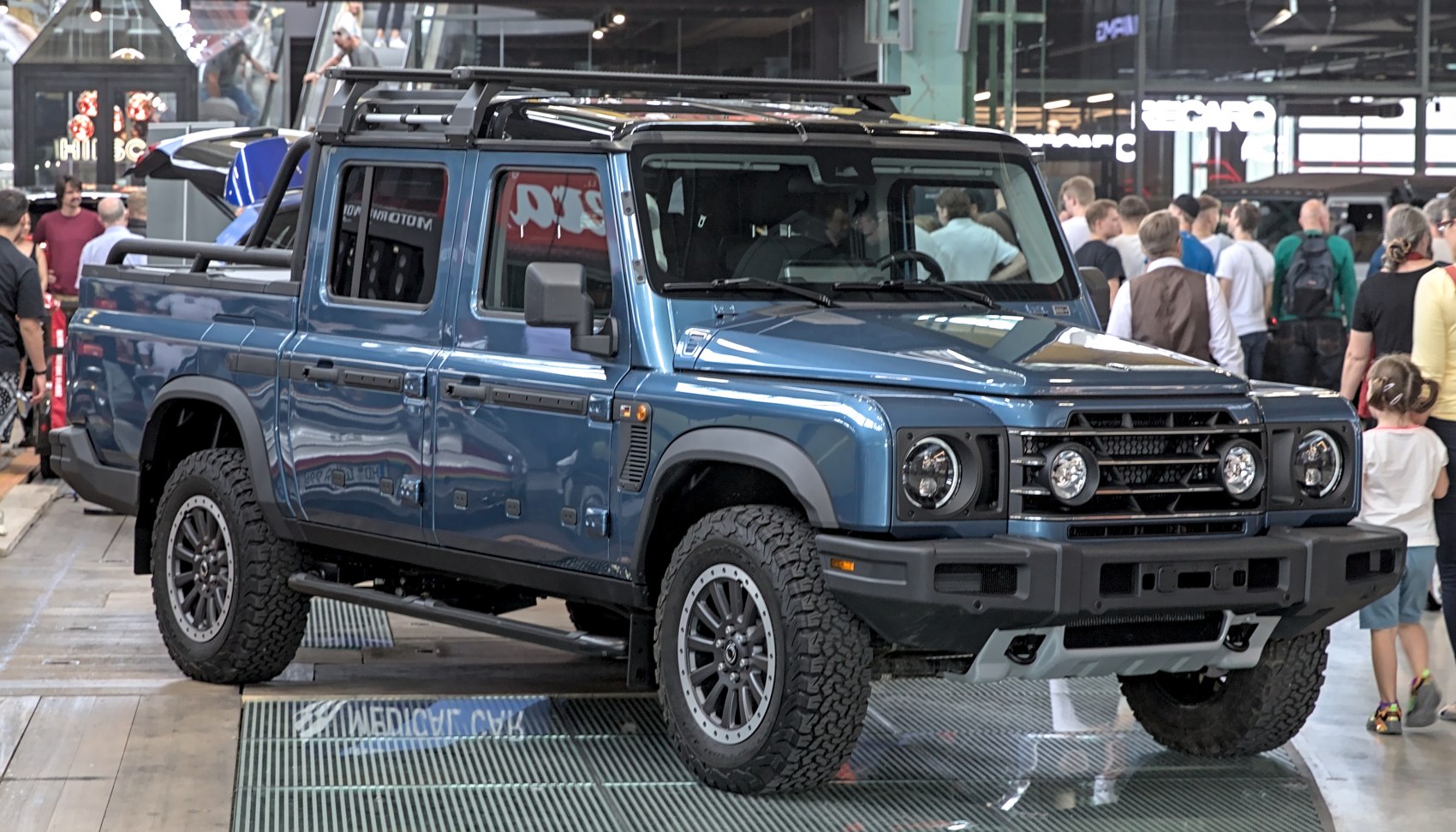 Double cab pickup truck with off-road tires and roof rack