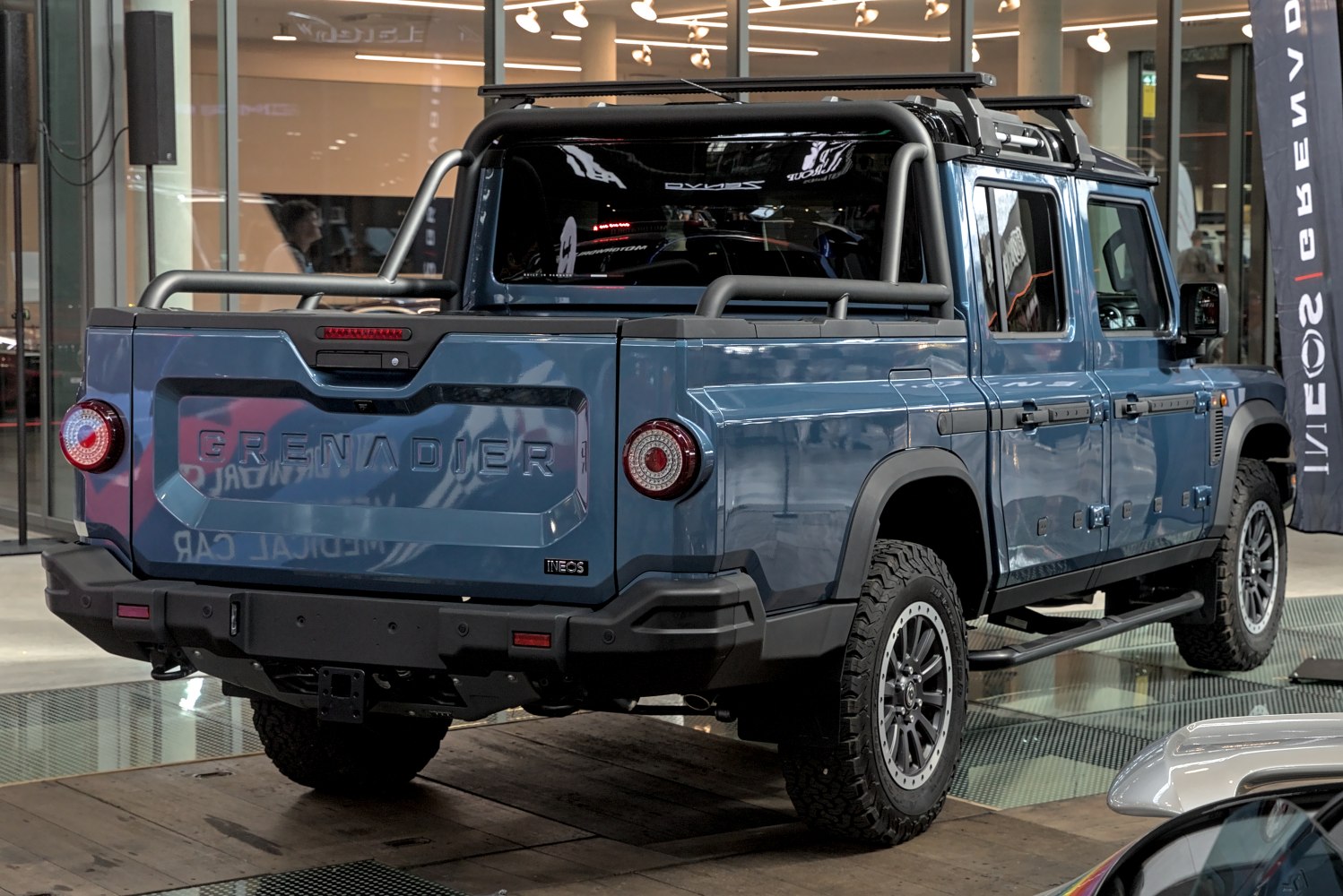 Rear view of rugged pickup with roof rack and all-terrain tires
