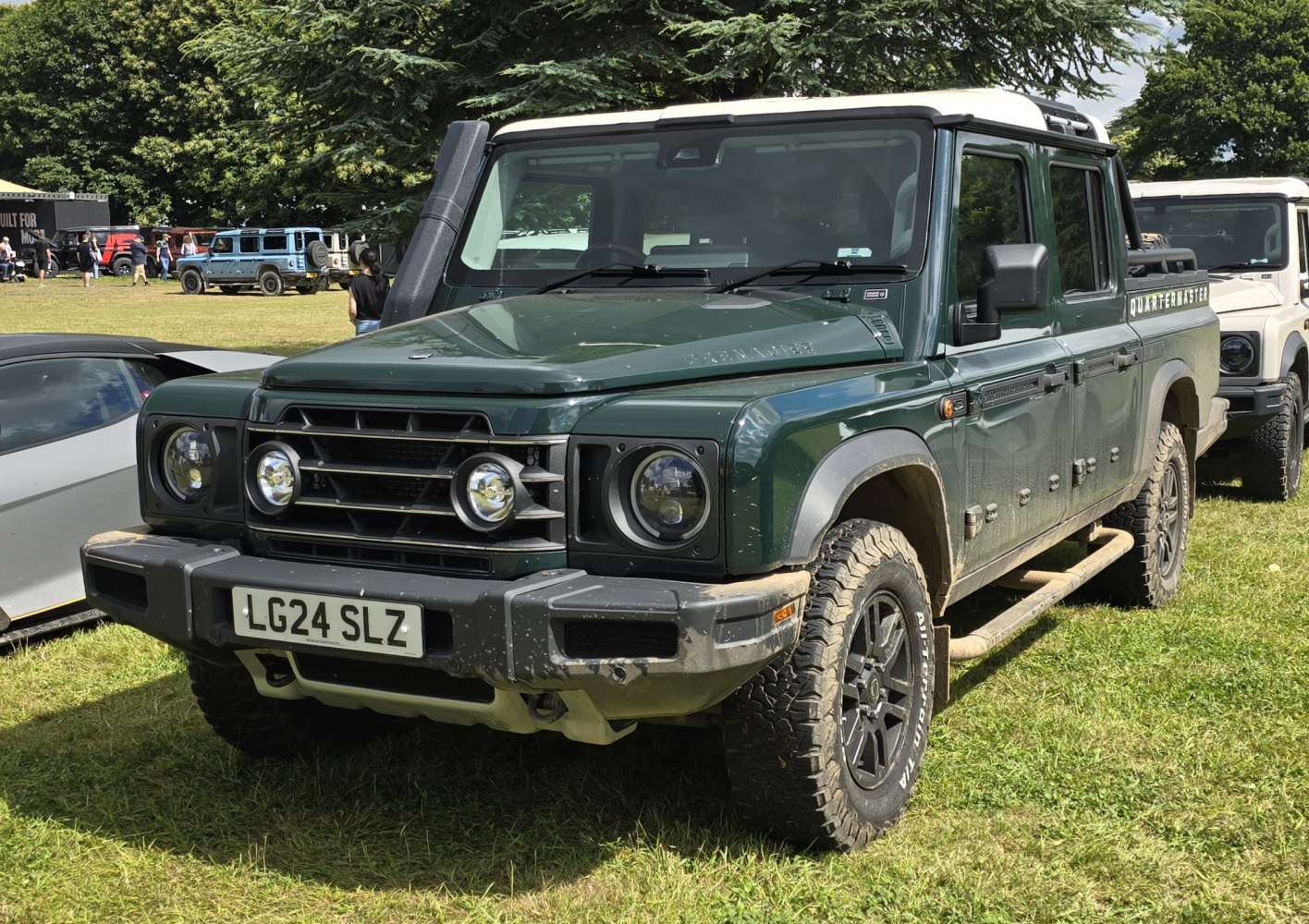 Green off-road SUV with snorkel, round headlights, and rugged tires