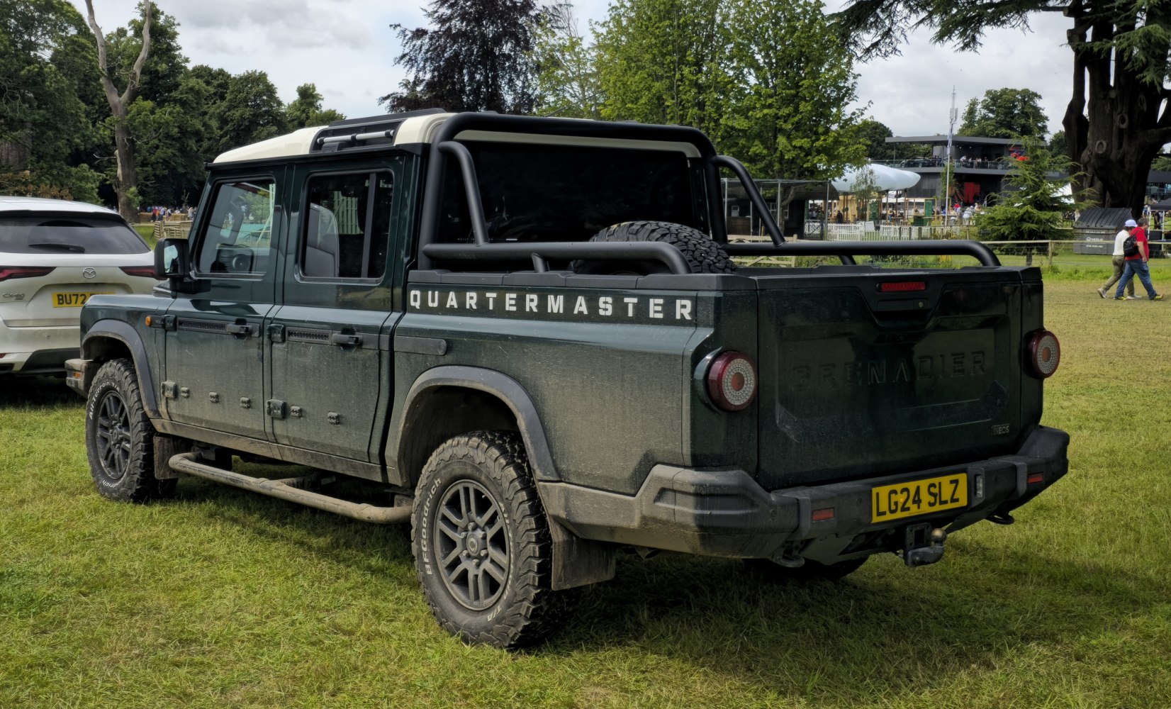 Rugged pickup truck with rear cargo bed and off-road tires