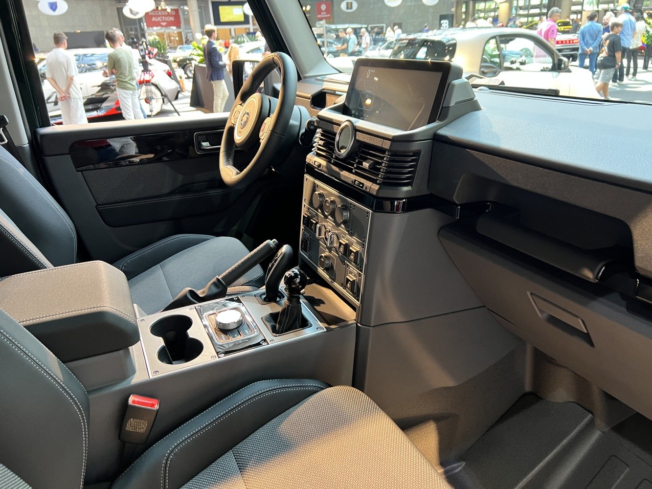 Modern vehicle interior with dashboard, digital display, and control panel