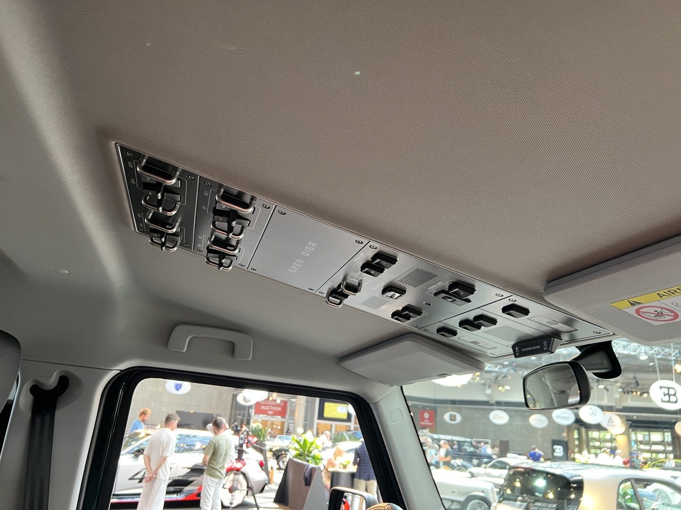 Overhead control panel with multiple toggle switches in SUV interior