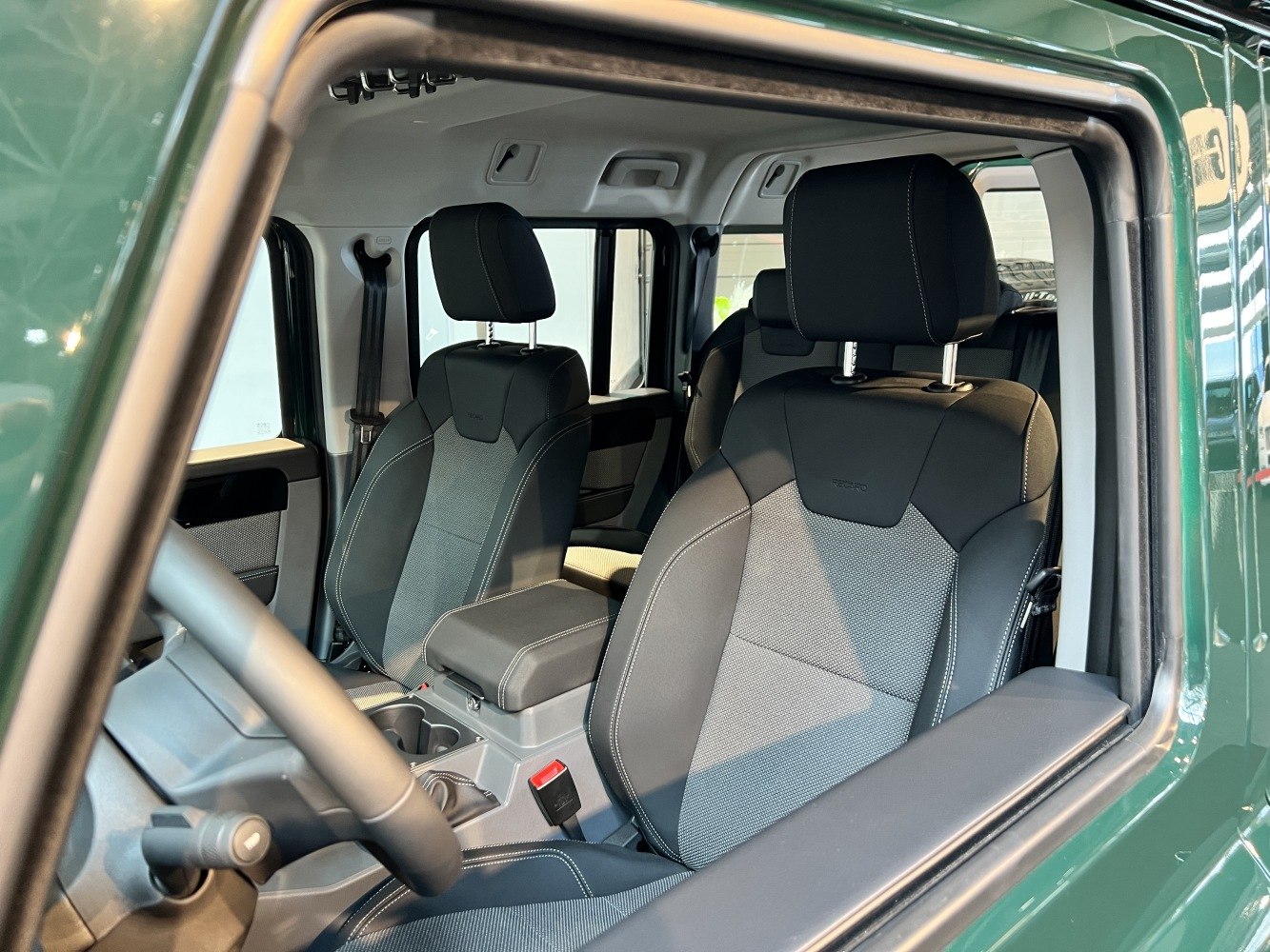 Front seats and interior view with ergonomic design and armrest.