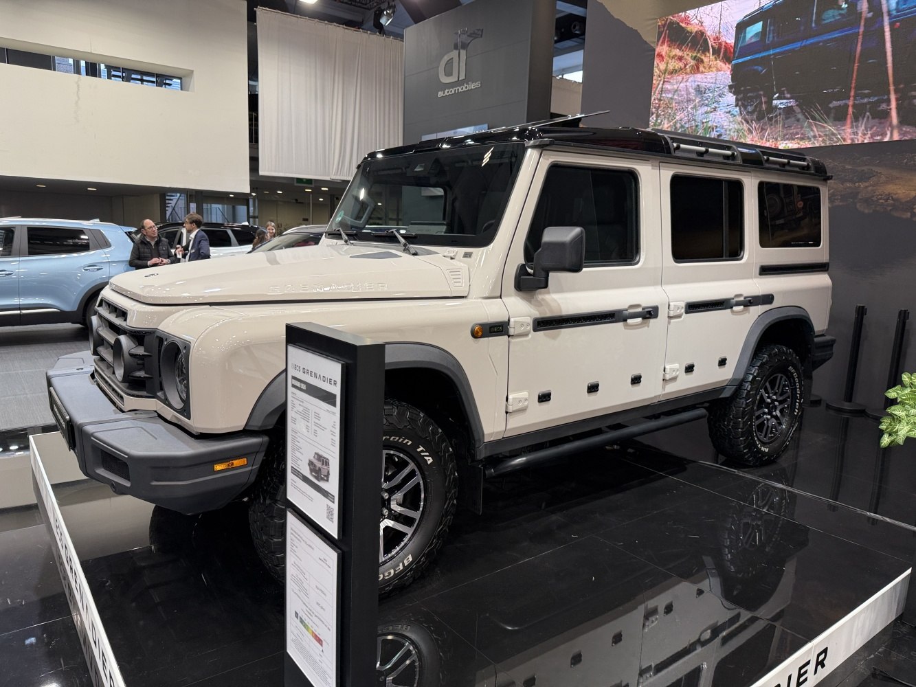 Beige rugged SUV with off-road tires and roof rack