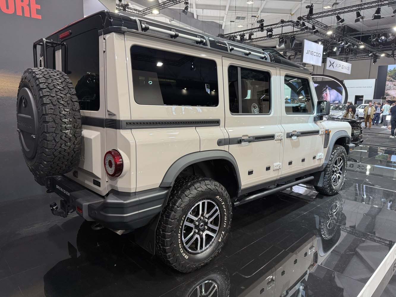 Beige rugged off-road SUV rear and side profile with spare wheel on rear door