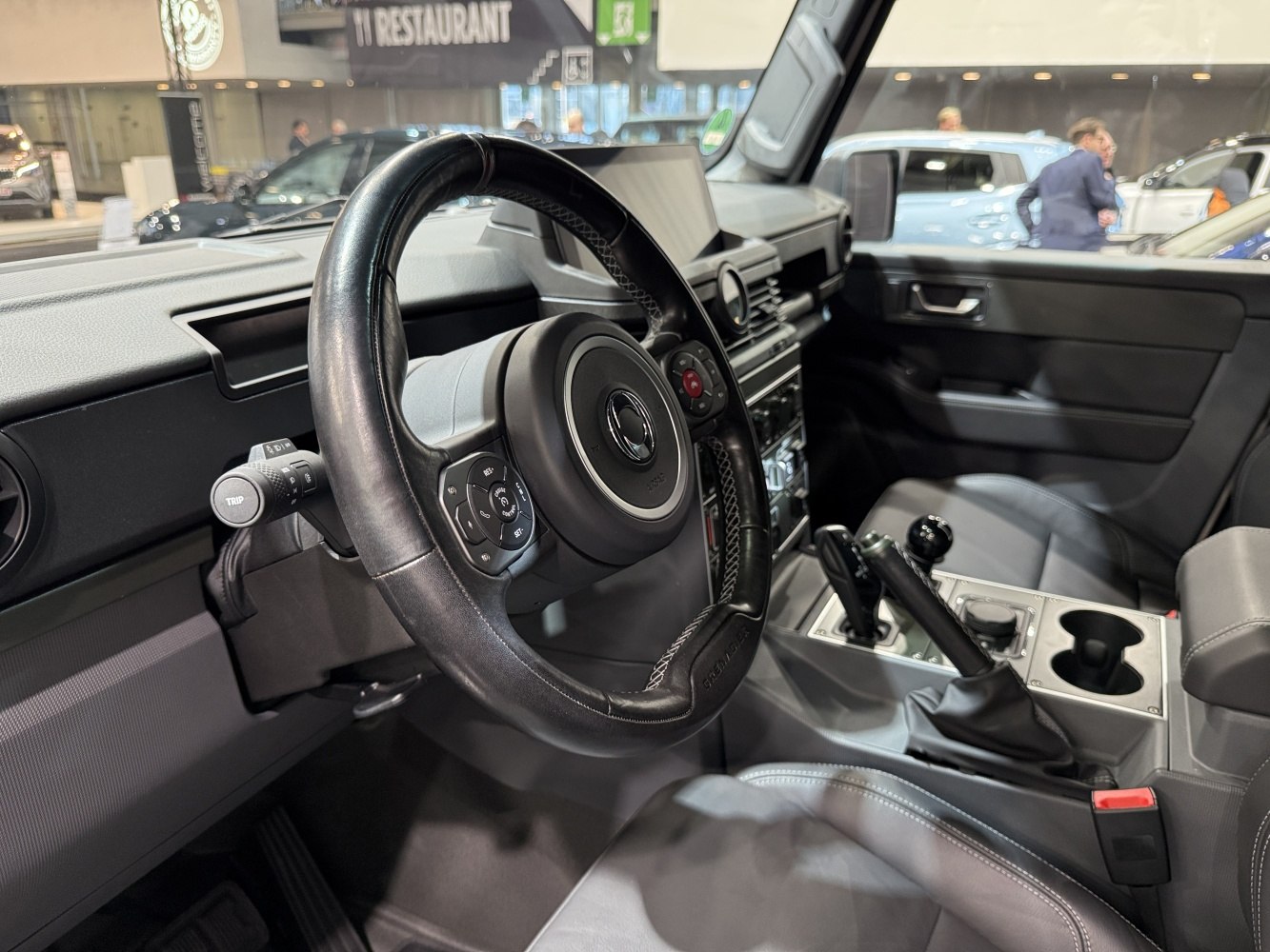 Steering wheel and center console of a rugged off-road vehicle interior