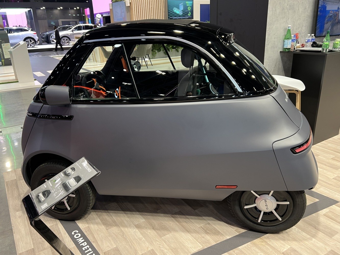 Compact microcar with single door and smooth, futuristic design