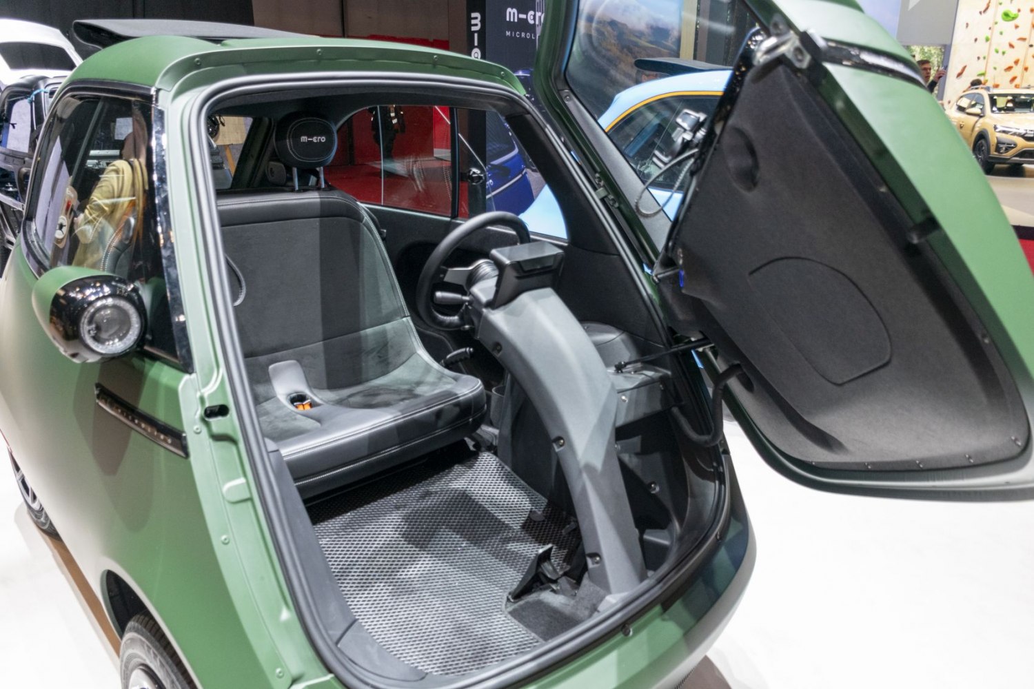 Single-seat front cabin with open front door of compact microcar