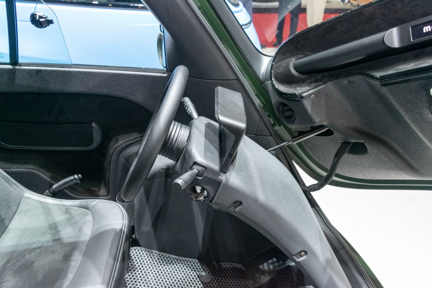 Steering wheel and dashboard details in compact microcar interior