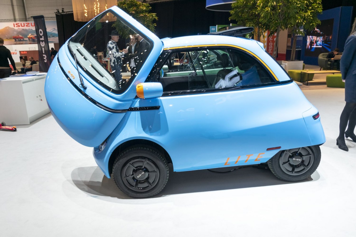 Unique front-opening door on compact, light blue electric microcar