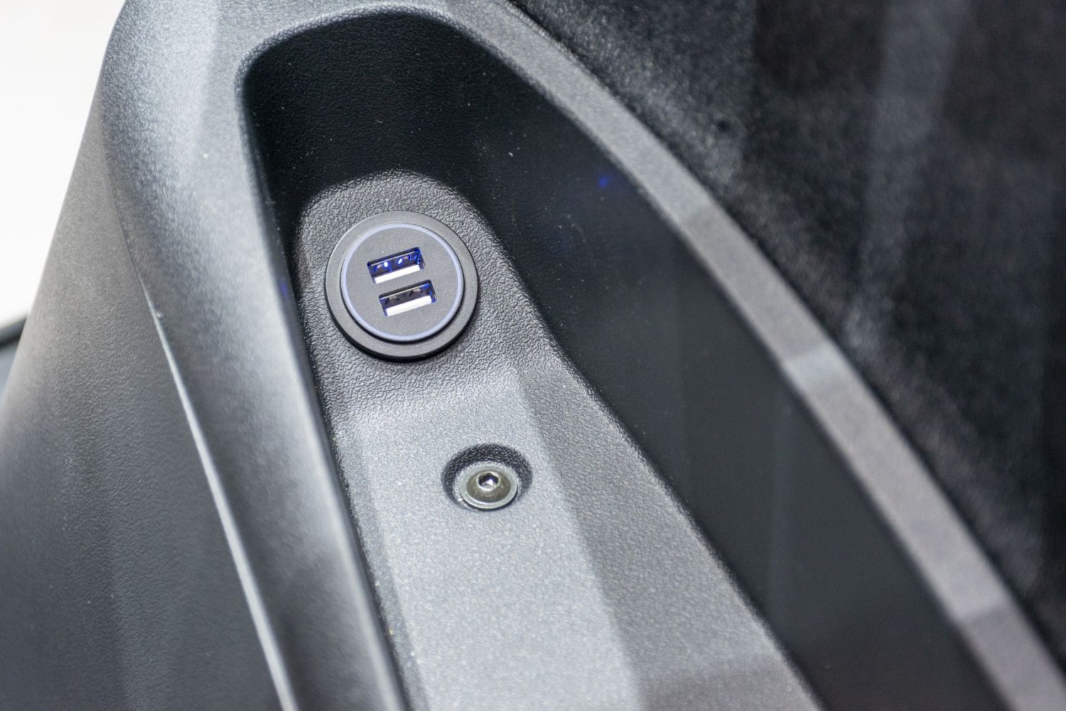 Dual USB charging ports mounted inside vehicle compartment