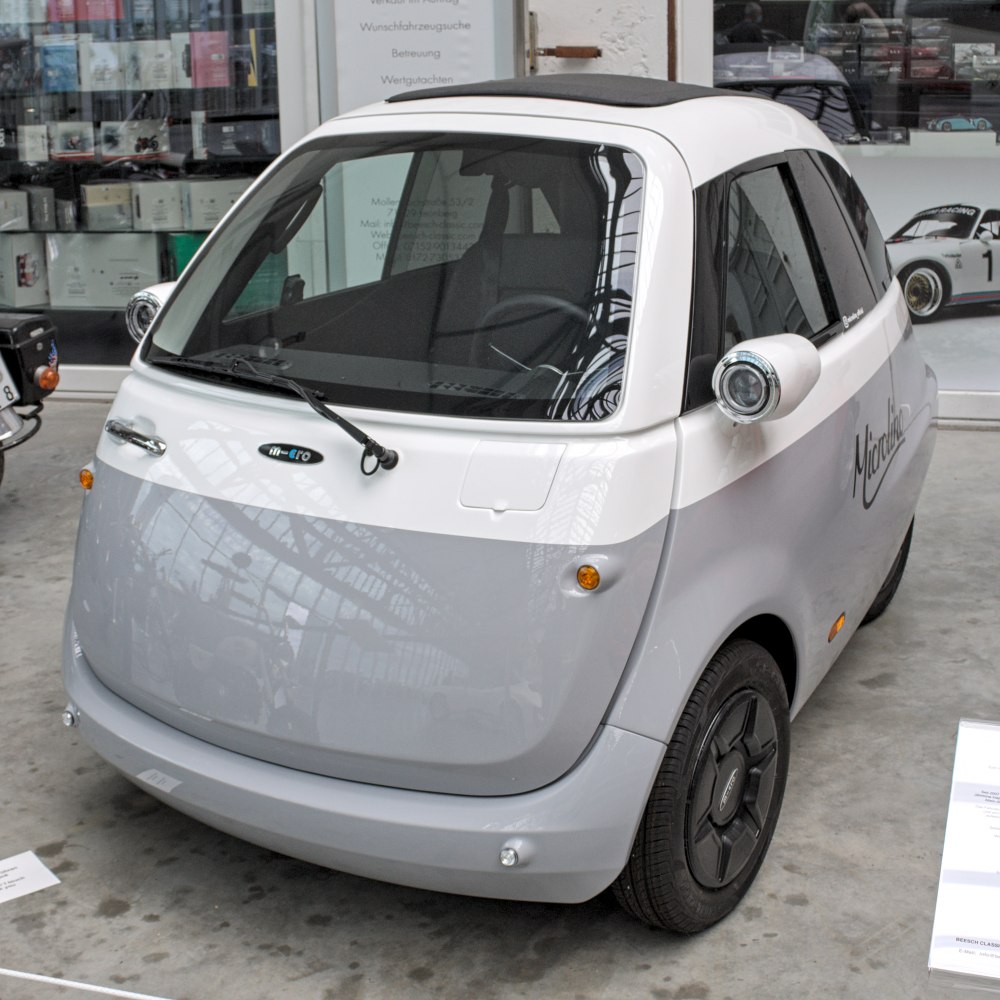Compact electric vehicle, round headlights, smooth front panel