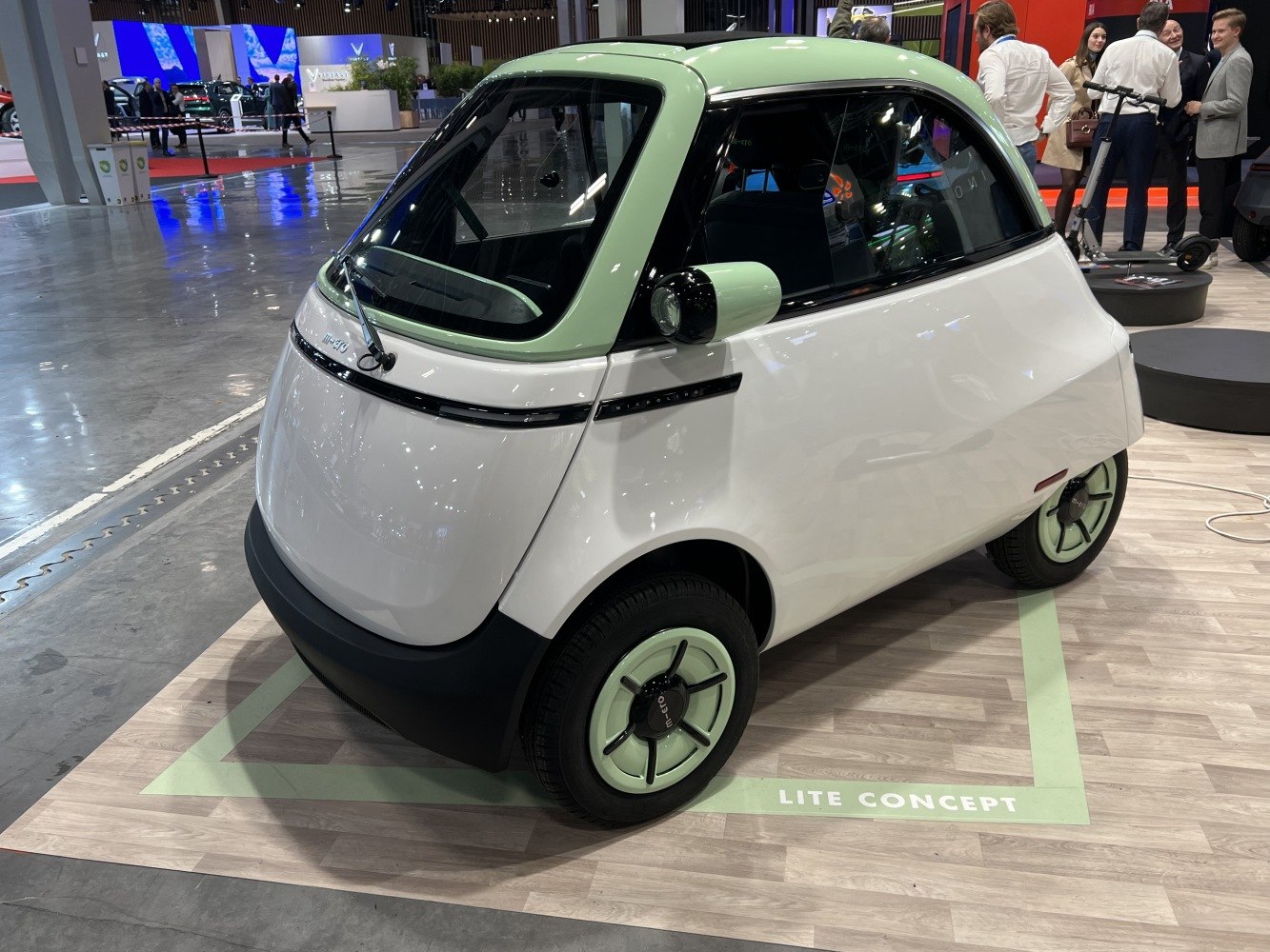 Compact three-wheel electric microvehicle with unique rear design and futuristic styling