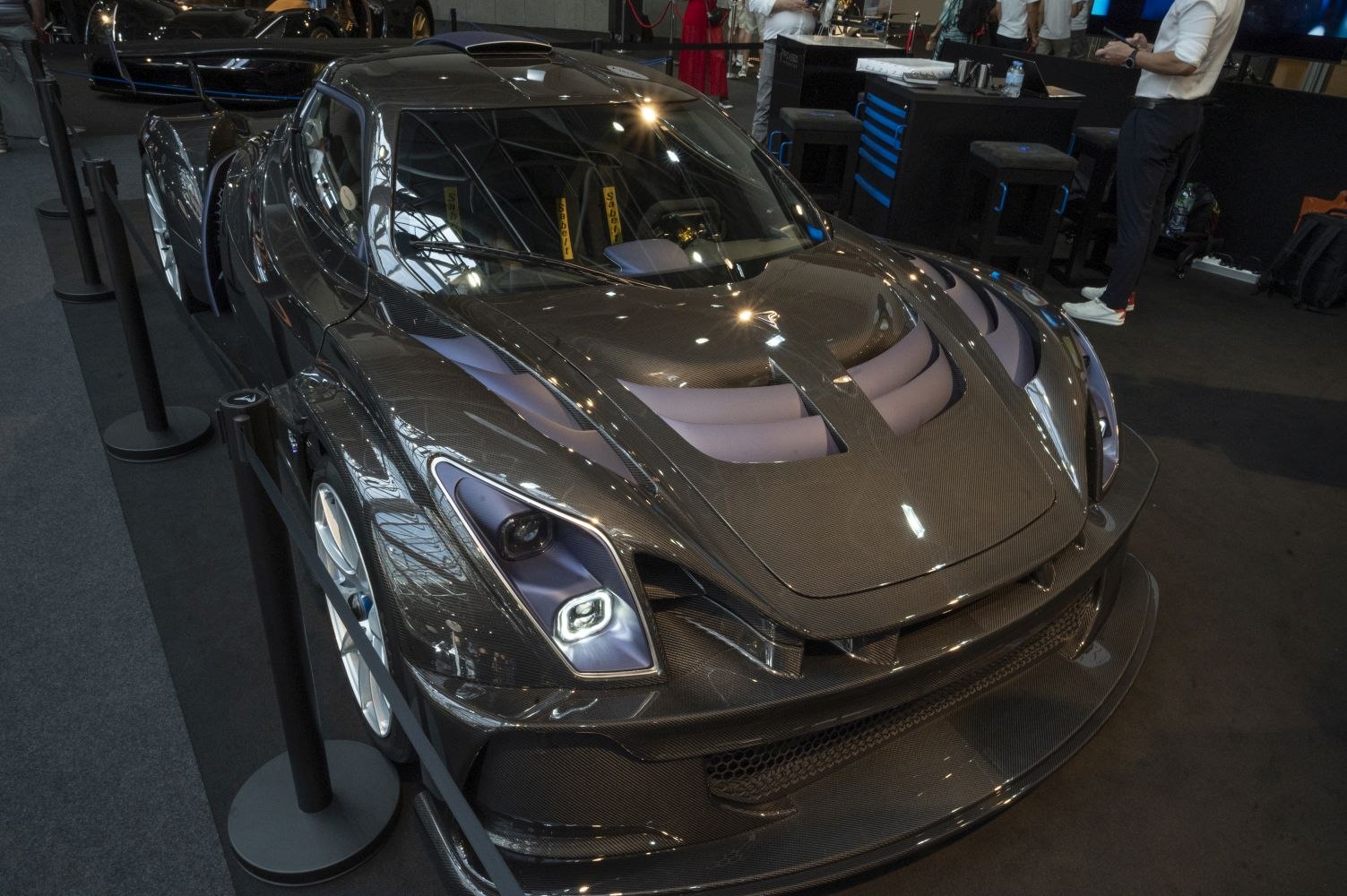 Carbon fiber body with aerodynamic front vents and race car headlights.