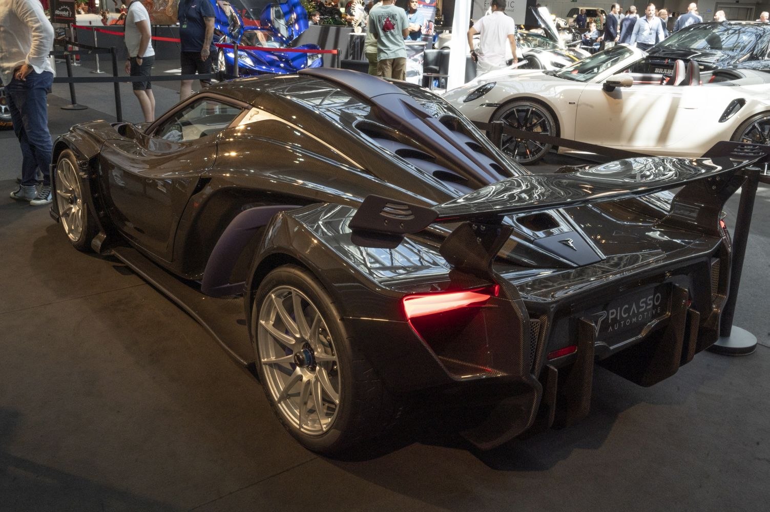 Aerodynamic rear wing and carbon fiber body features