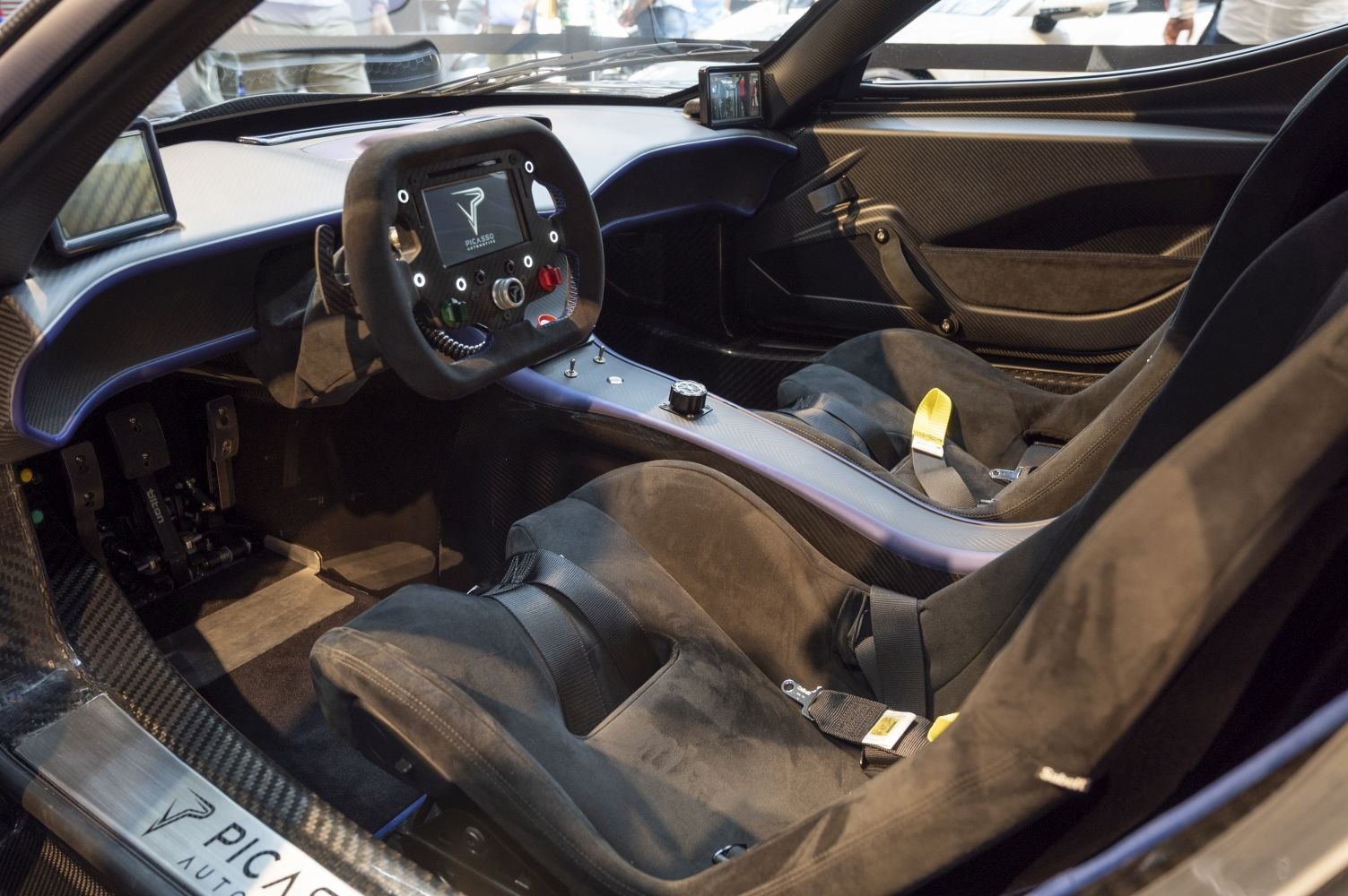Racing car interior with carbon fiber dashboard and bucket seats