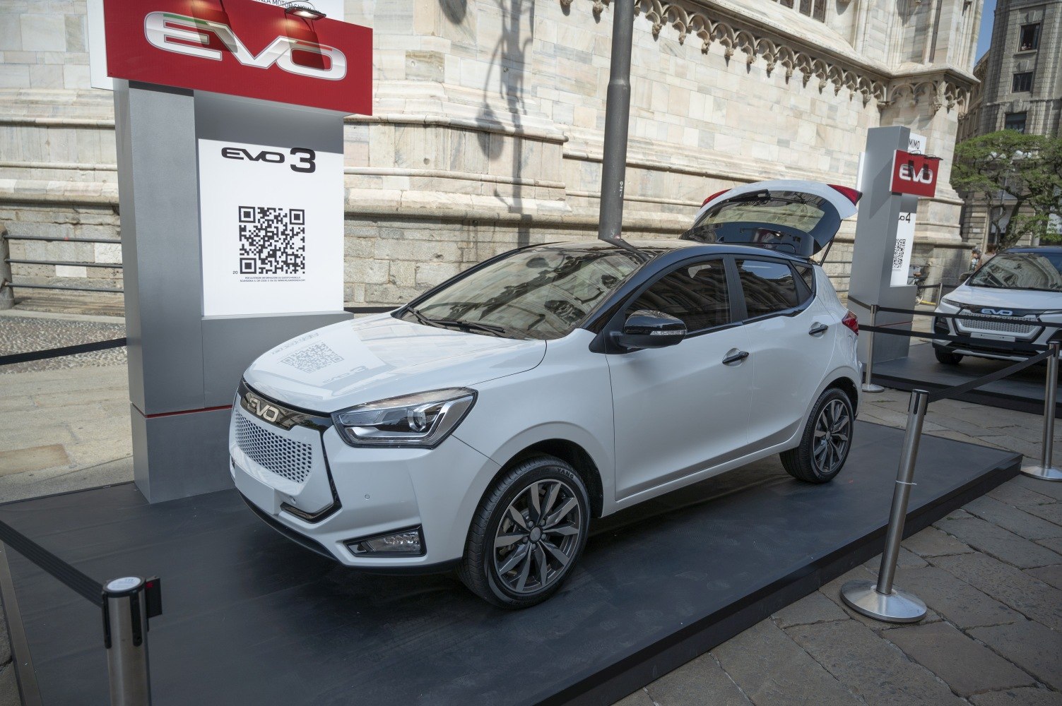 White hatchback with LED headlights, alloy wheels, and open tailgate.
