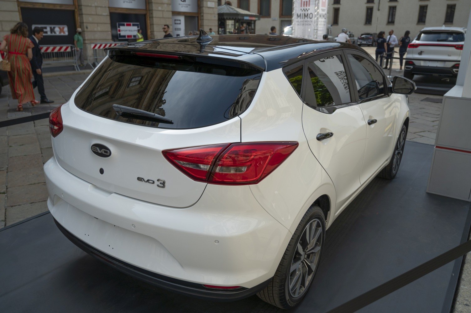 Rear view with sleek taillights, black roof, and alloy wheels