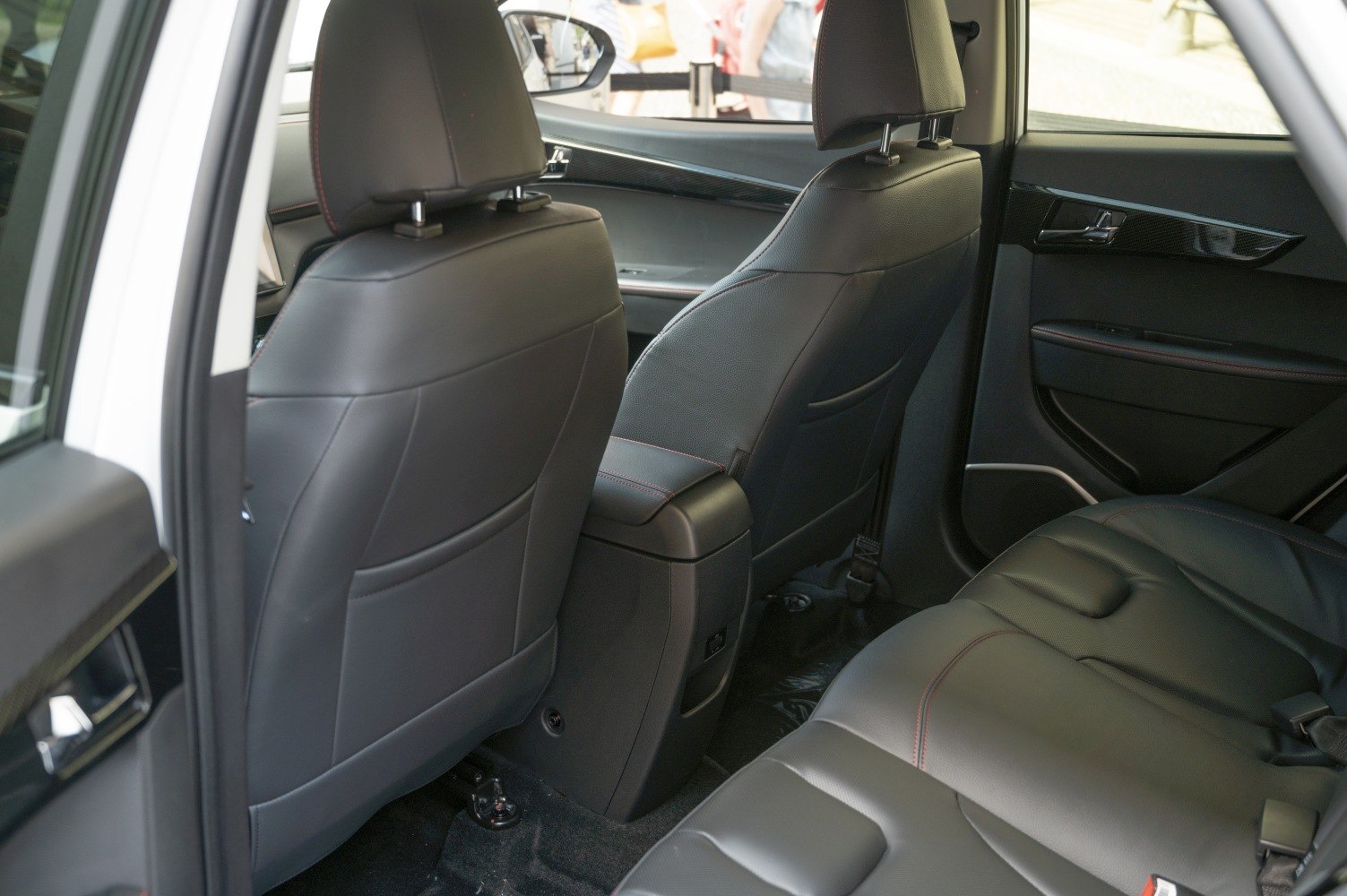 Rear cabin with black leather seats and door trim