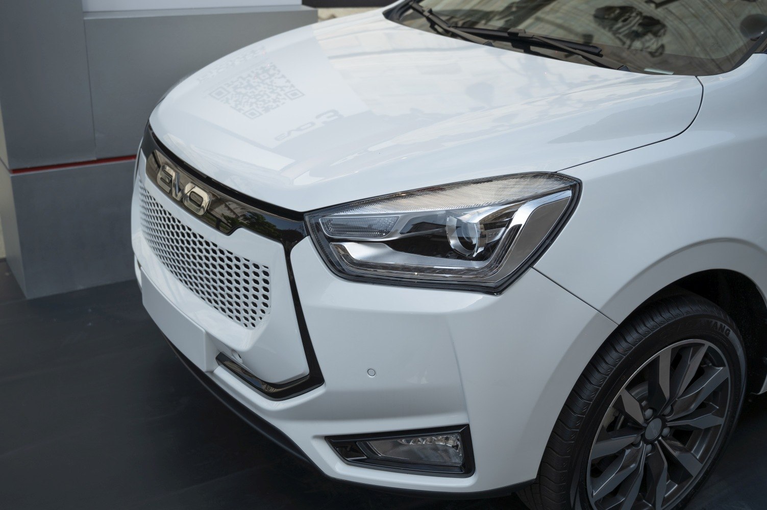 Front end close-up with detailed headlight and grille design